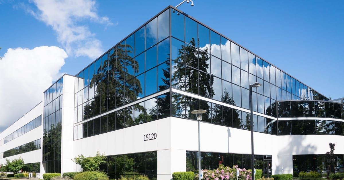 A large office building with a lot of windows on a sunny day.