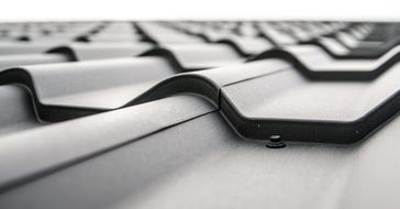 A close up of a black roof with a white background.