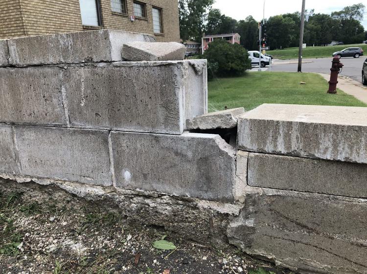 A brick wall with a fire hydrant in the background