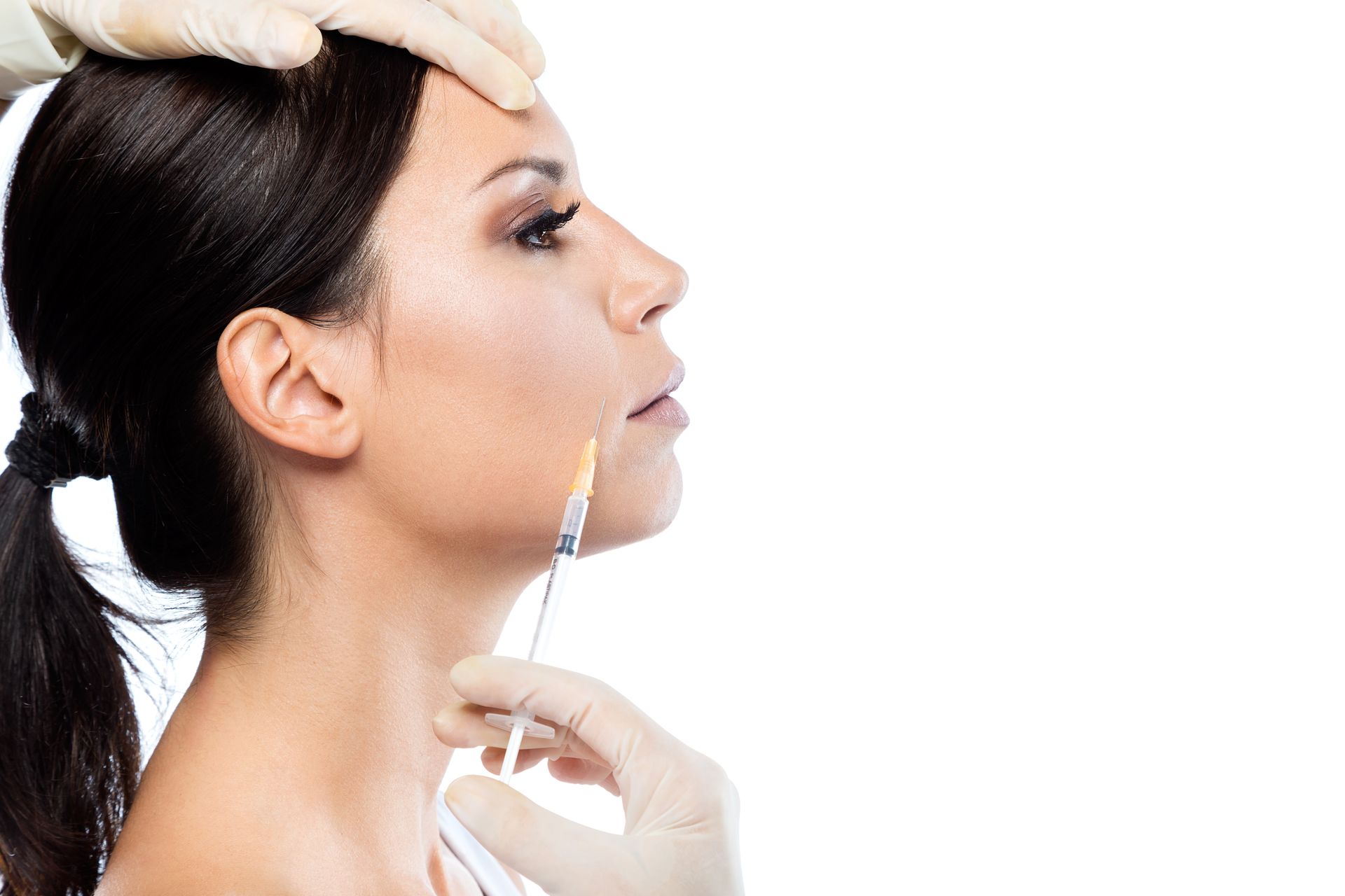 A woman is getting a botox injection in her face.