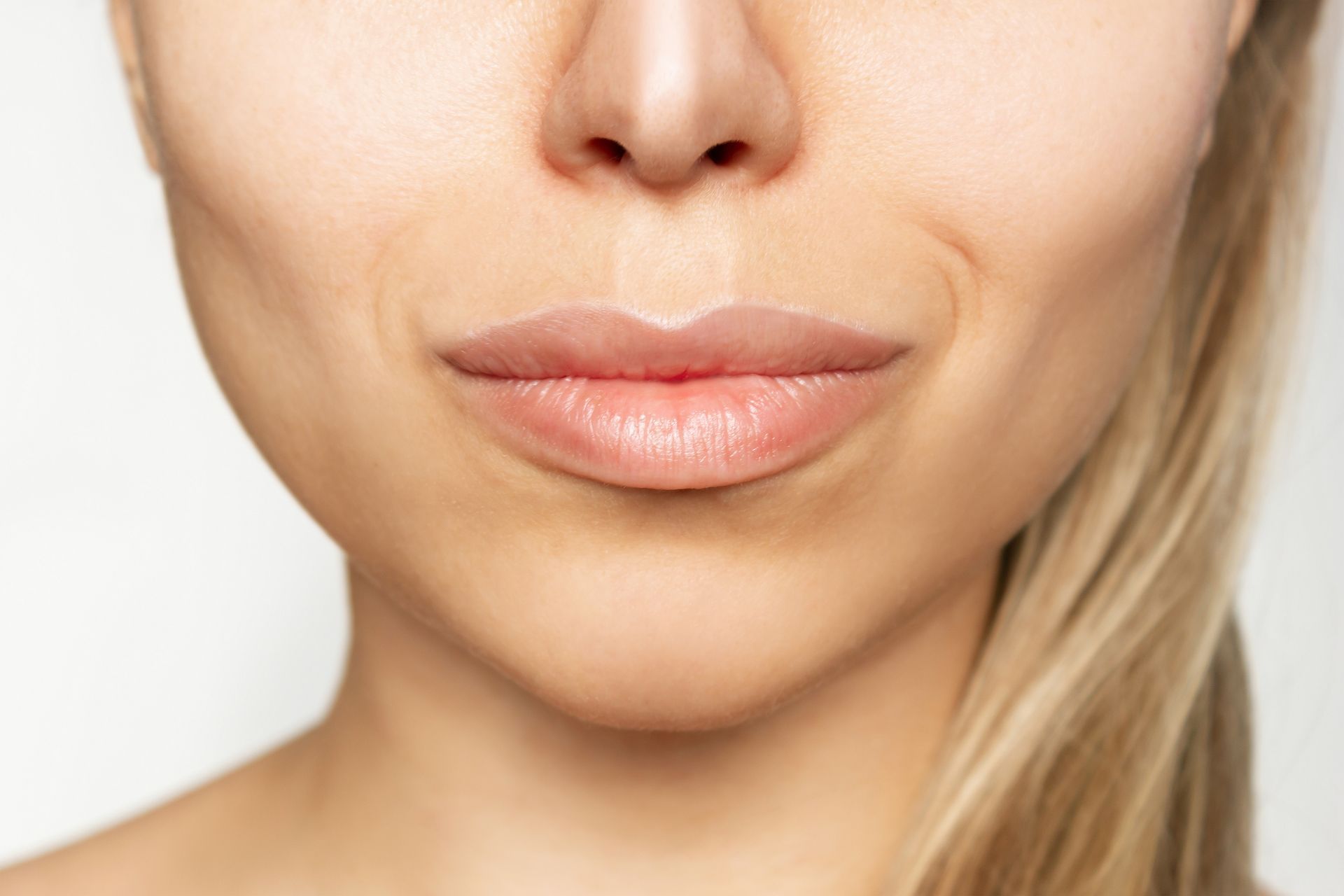 A close up of a woman 's lips with a smile on her face.