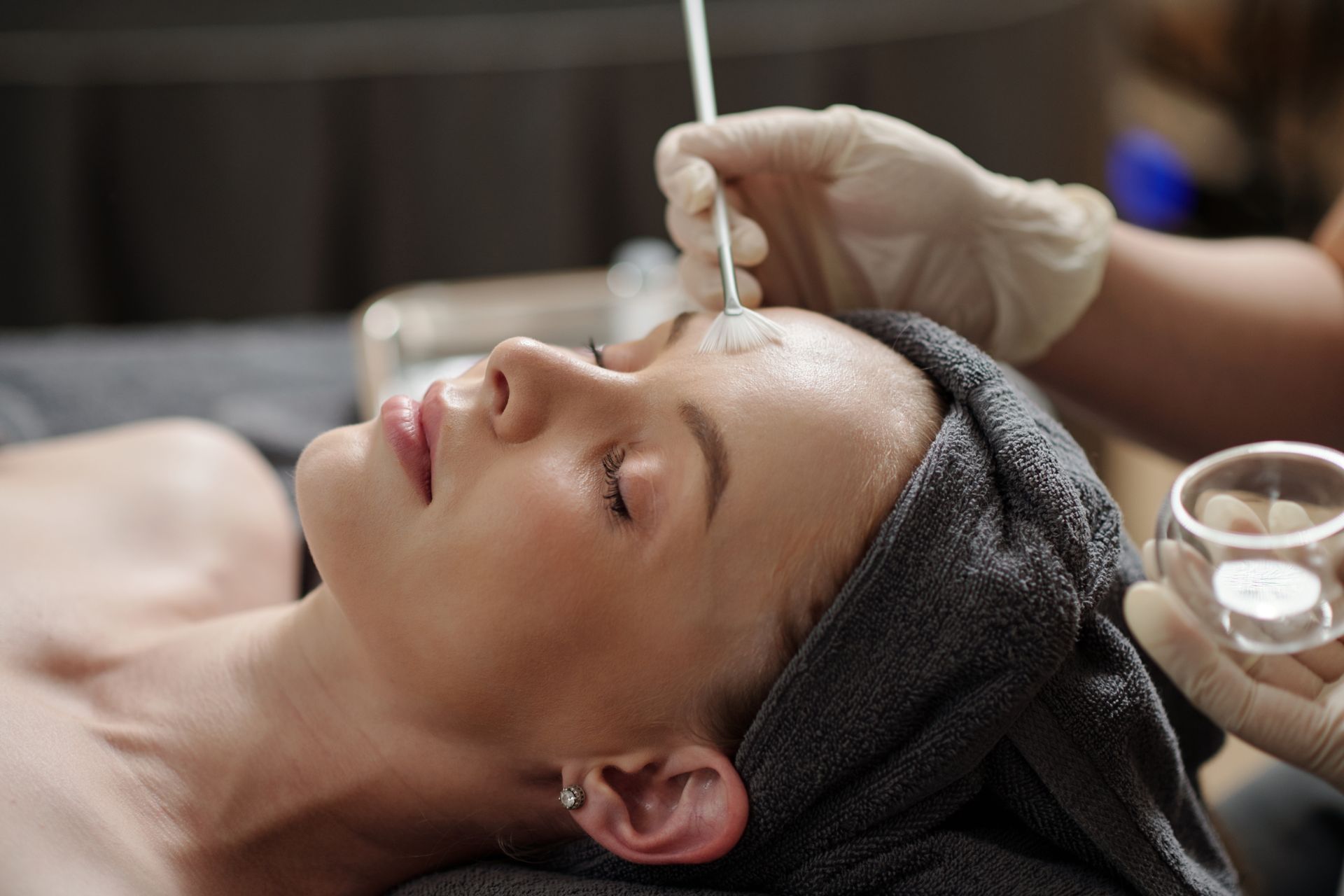 A woman is getting a facial treatment in a beauty salon.