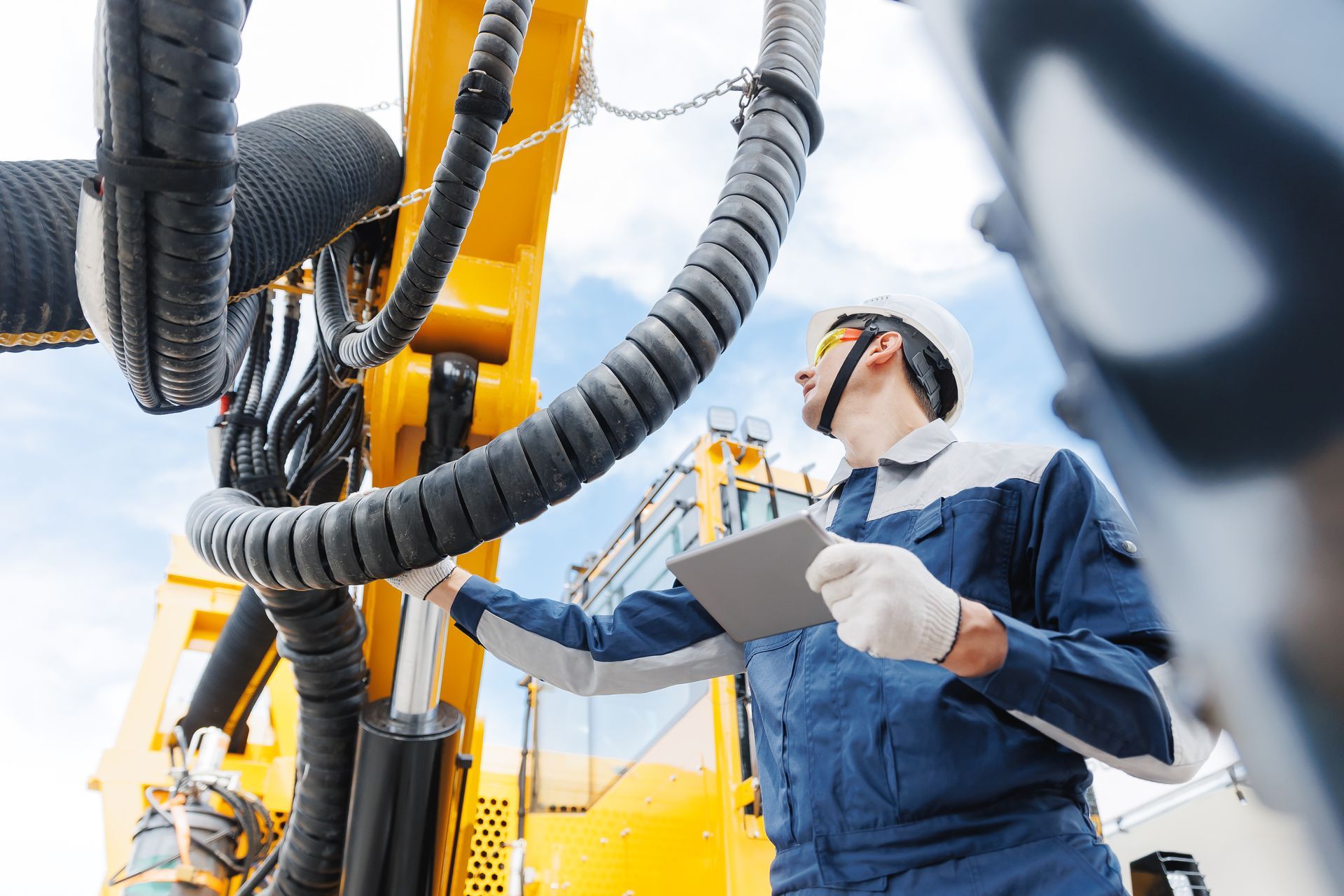 A mechanic uses a yellow and black hydraulic equipment from a supplier. A mechanic uses a yellow and black hydraulic equipment from a supplier.