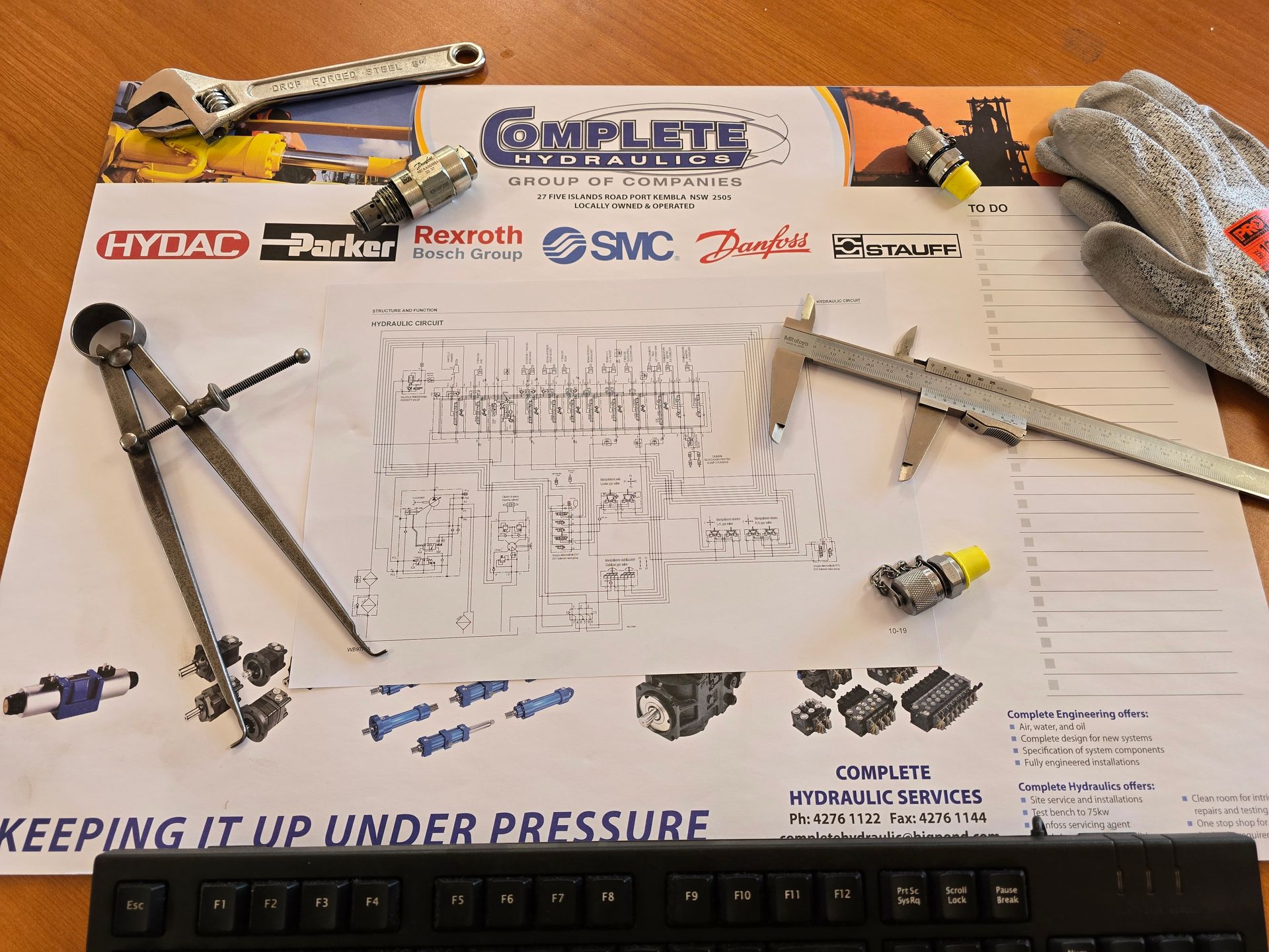 Two men are working on a machine in a factory.