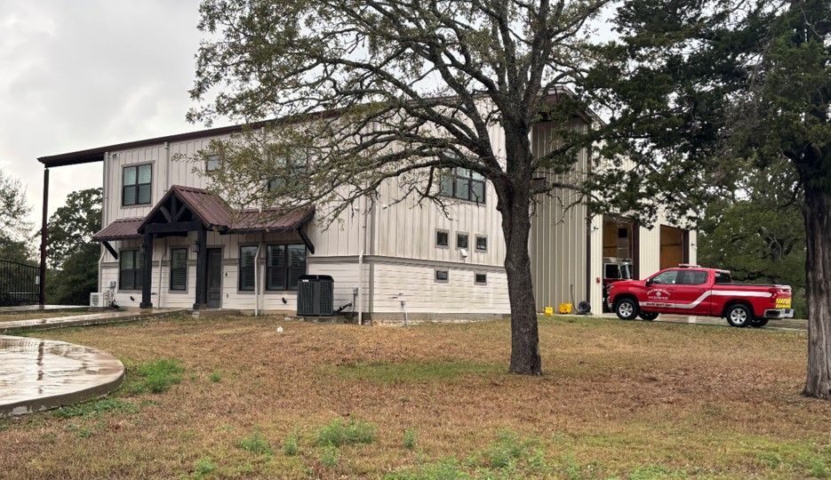 A fire station building with a red trim has a lot of garage doors