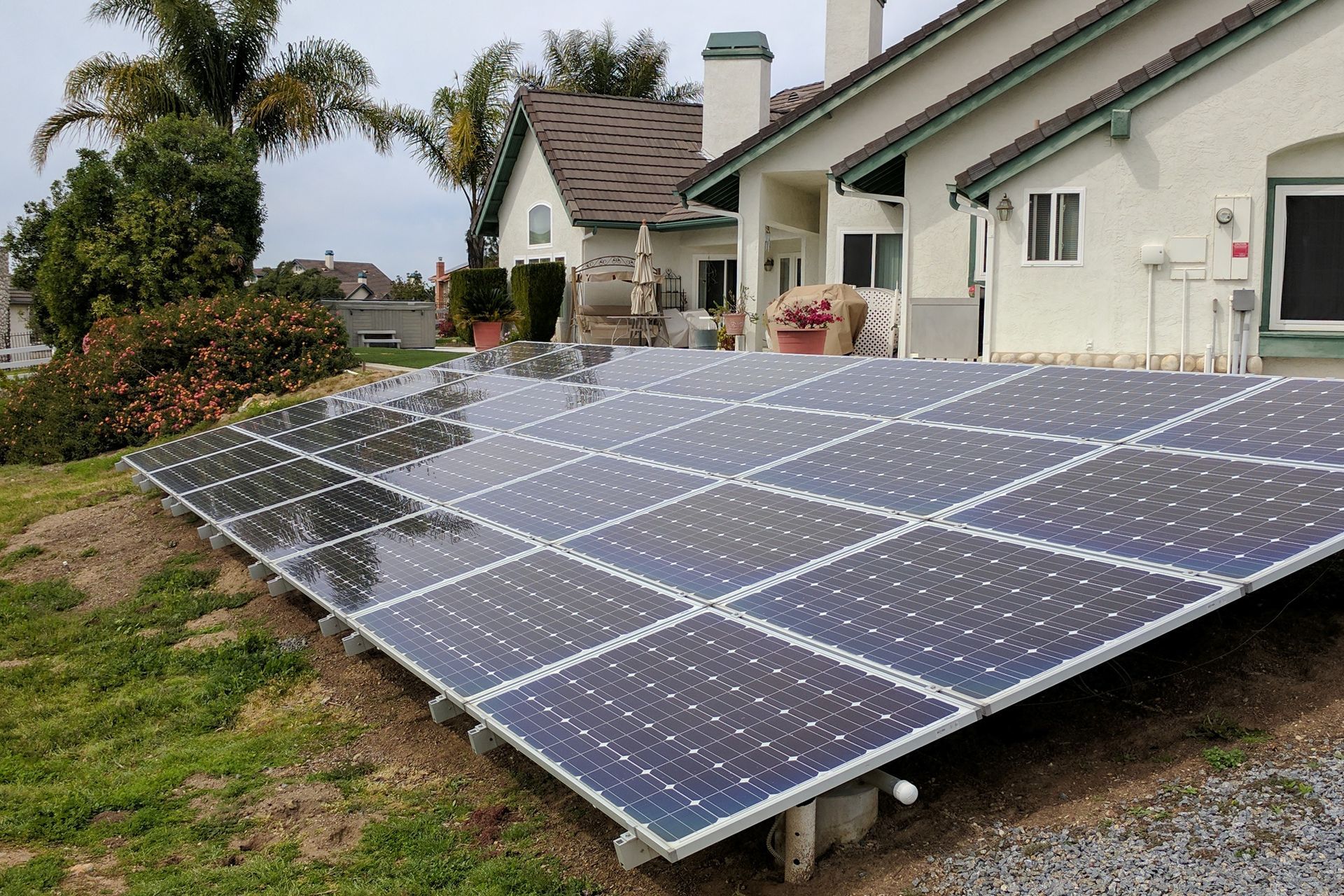 A row of solar panels in front of a house