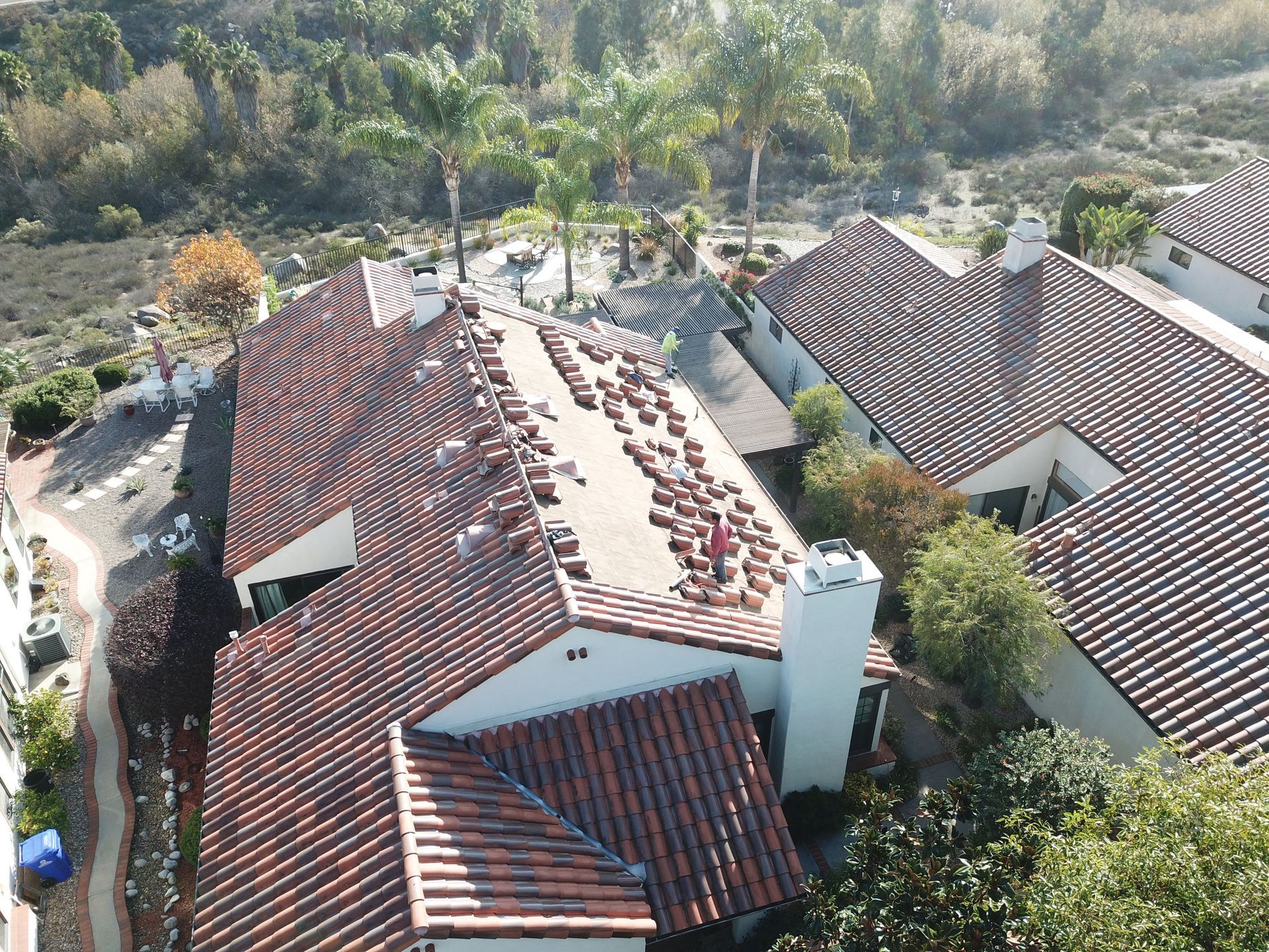 An aerial view of a row of houses with tiled roofs