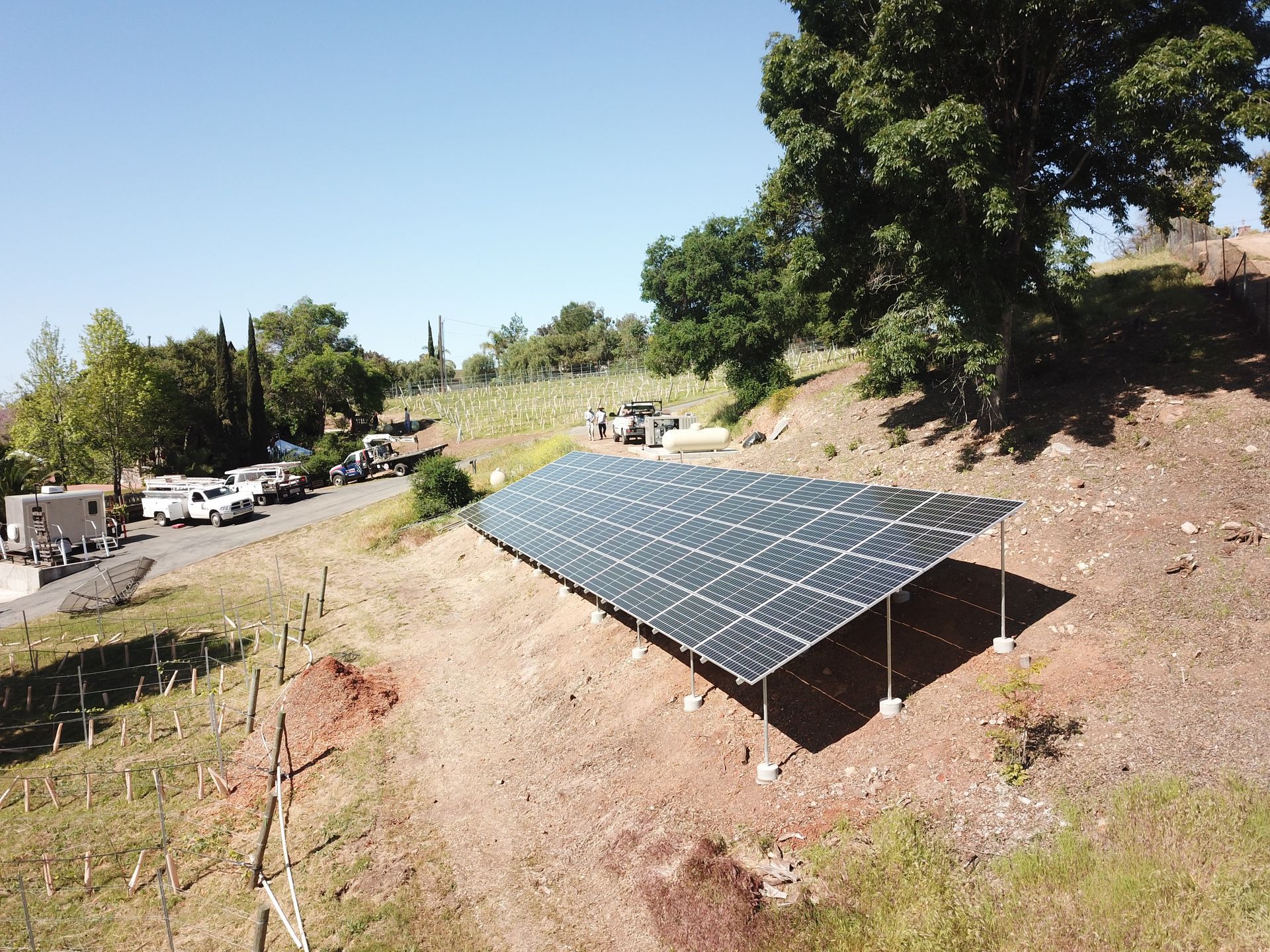 An aerial view of a solar panel on top of a hill.