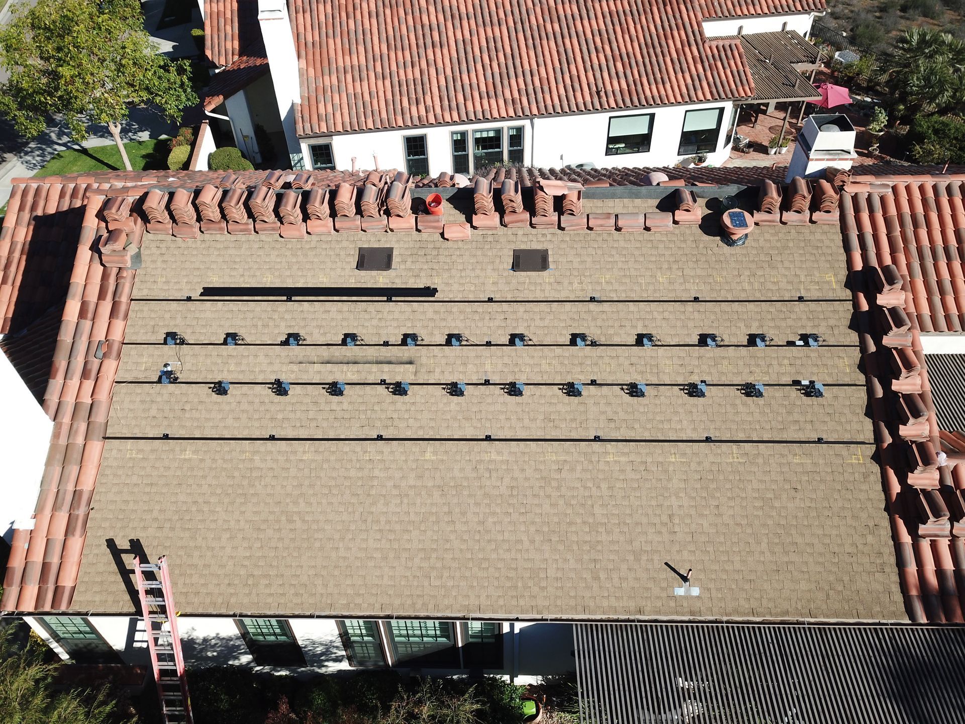 An aerial view of a roof with solar panels on it