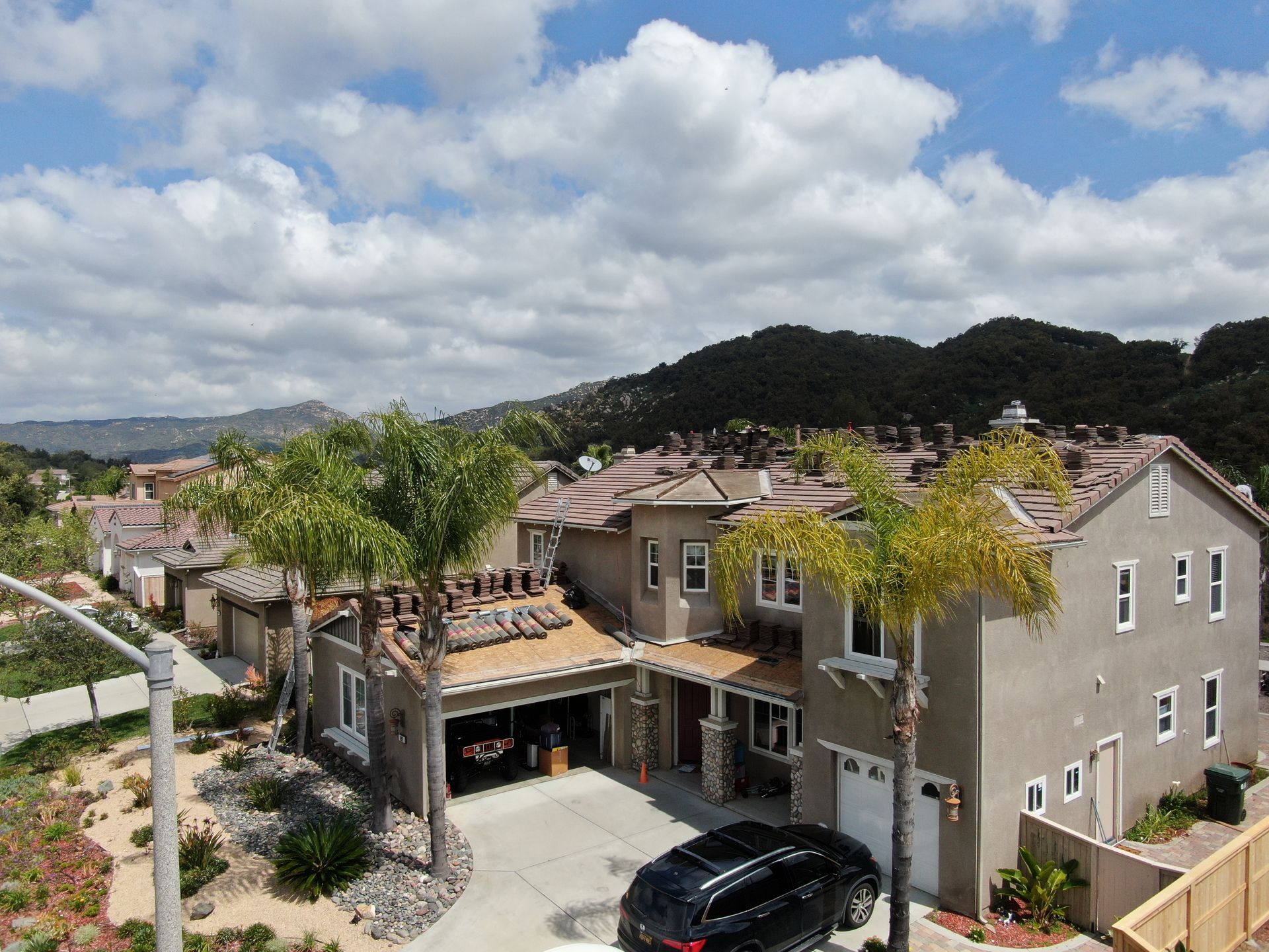An aerial view of a house with a car parked in front of it