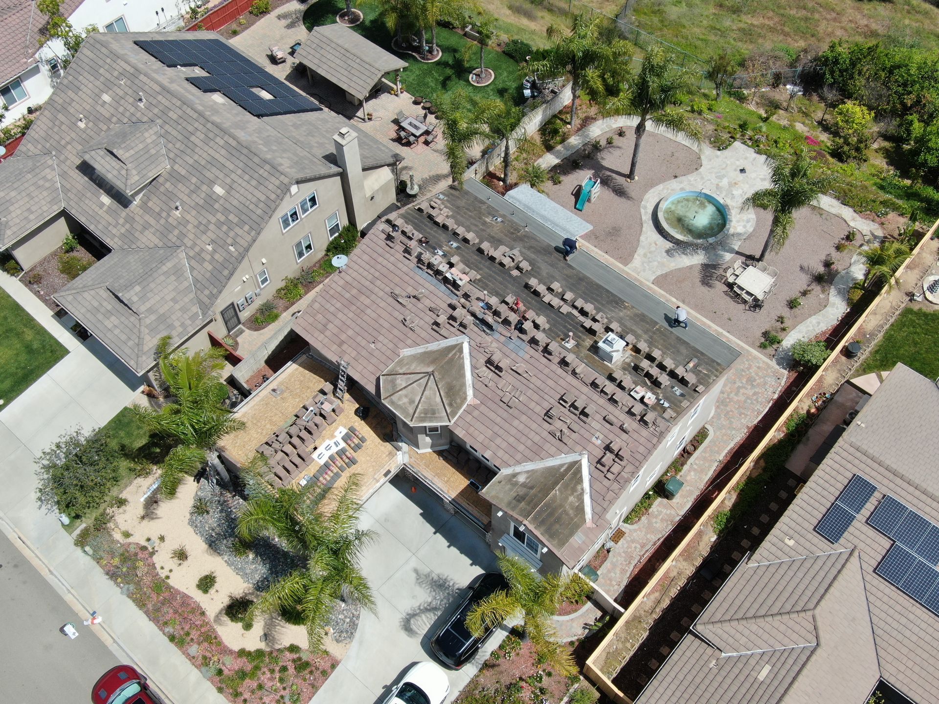 An aerial view of a house with solar panels on the roof