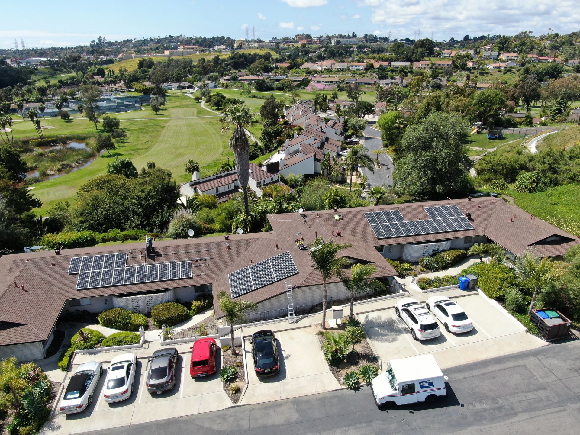 An aerial view of a house with solar panels on the roof