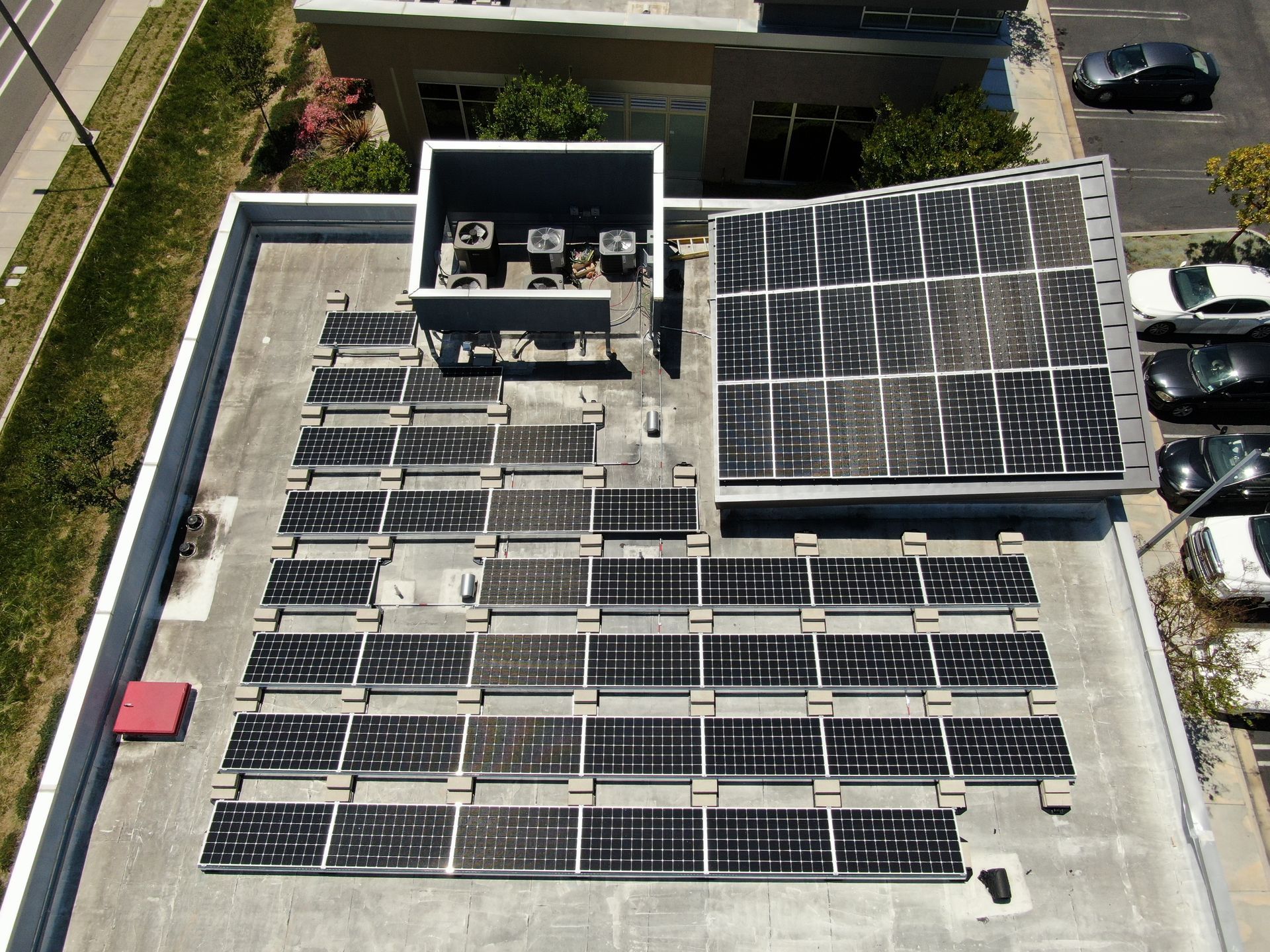 An aerial view of solar panels on the roof of a building