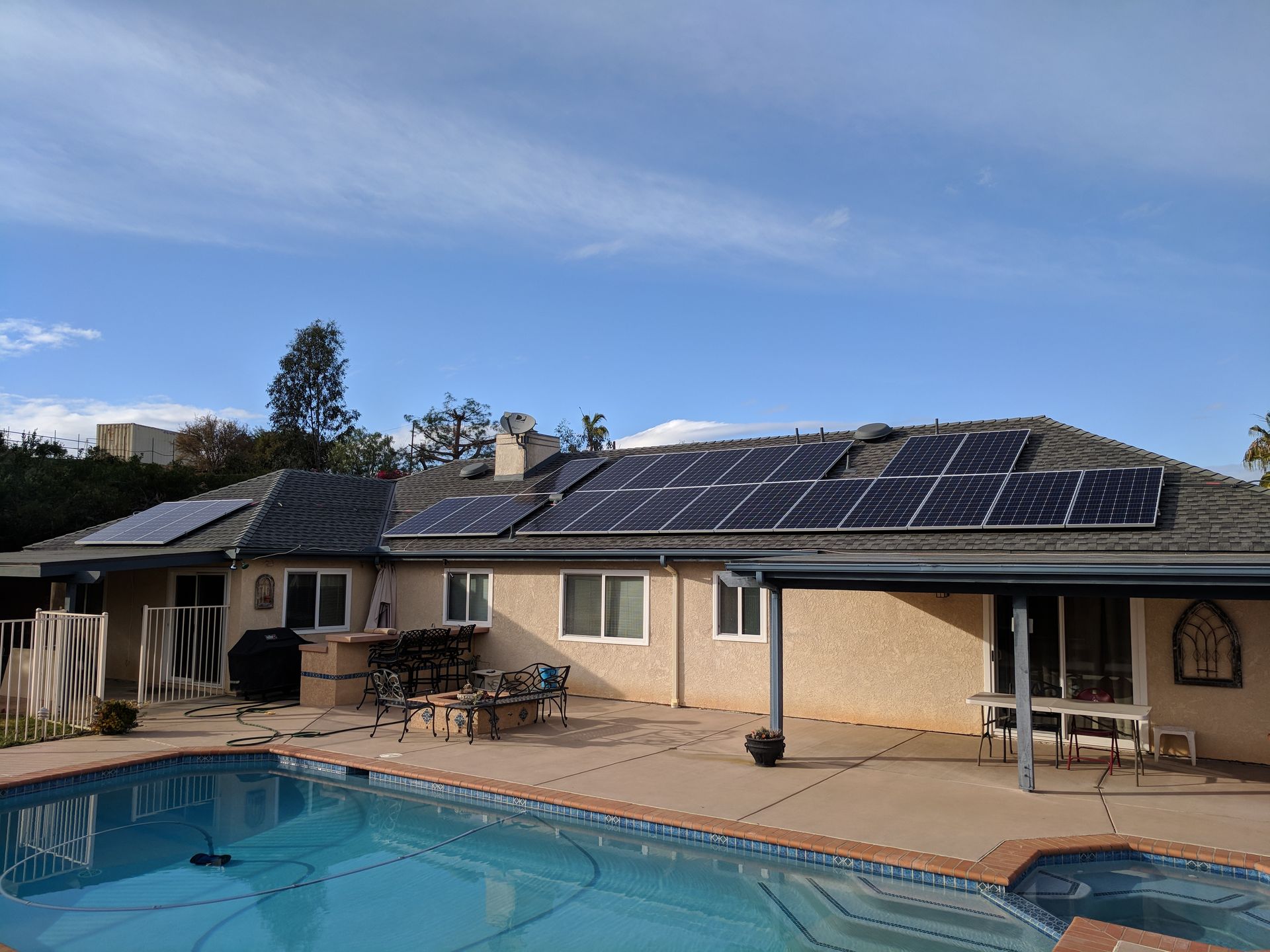 A house with a pool and solar panels on the roof.