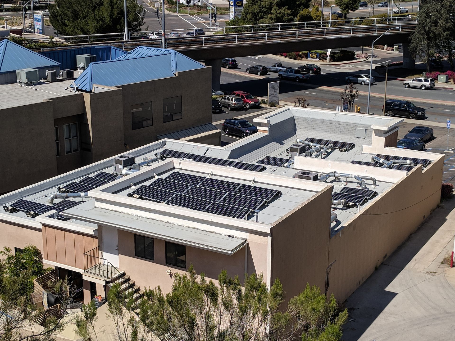 An aerial view of a building with solar panels on the roof