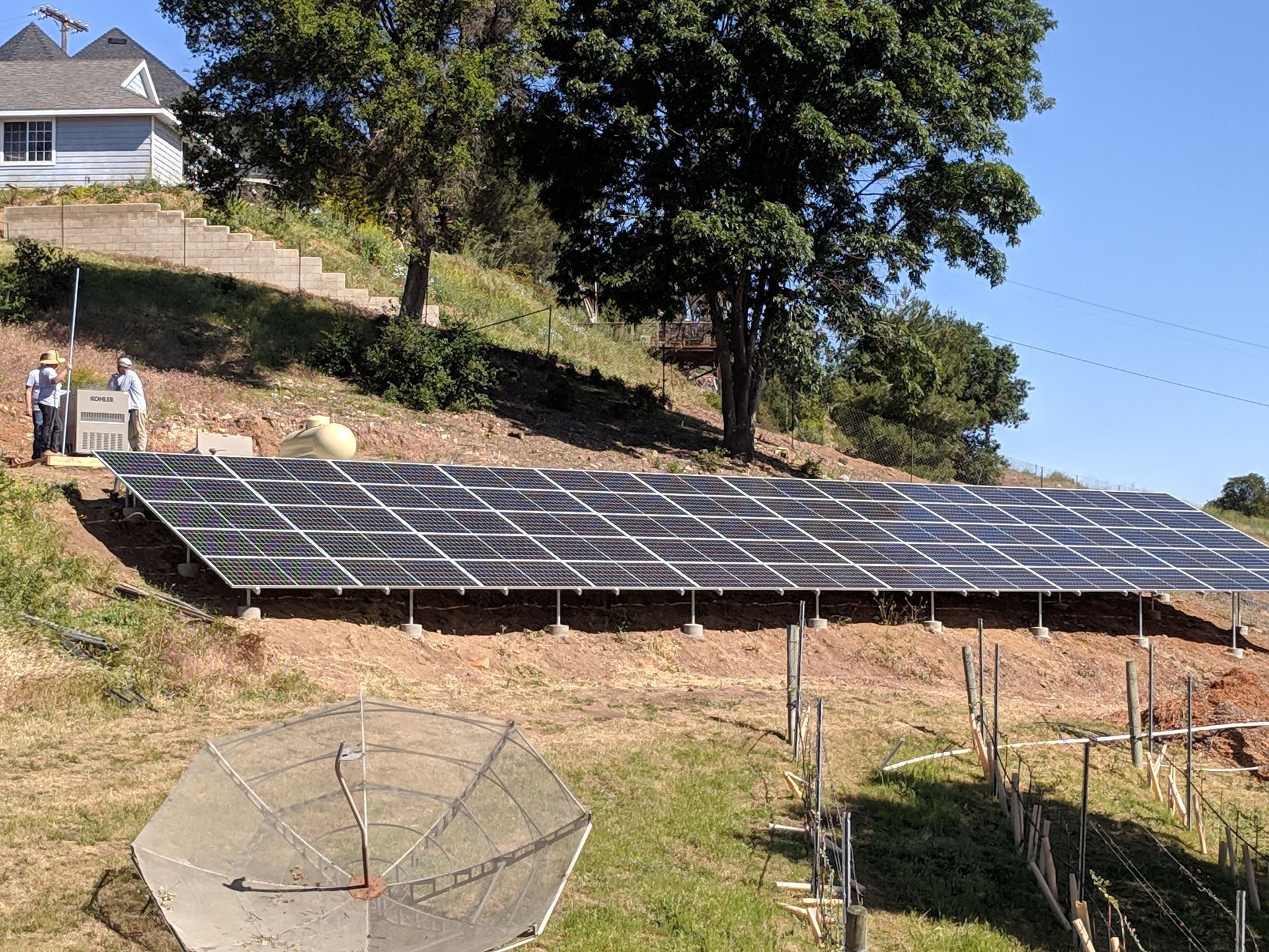 A group of solar panels are sitting on top of a hill