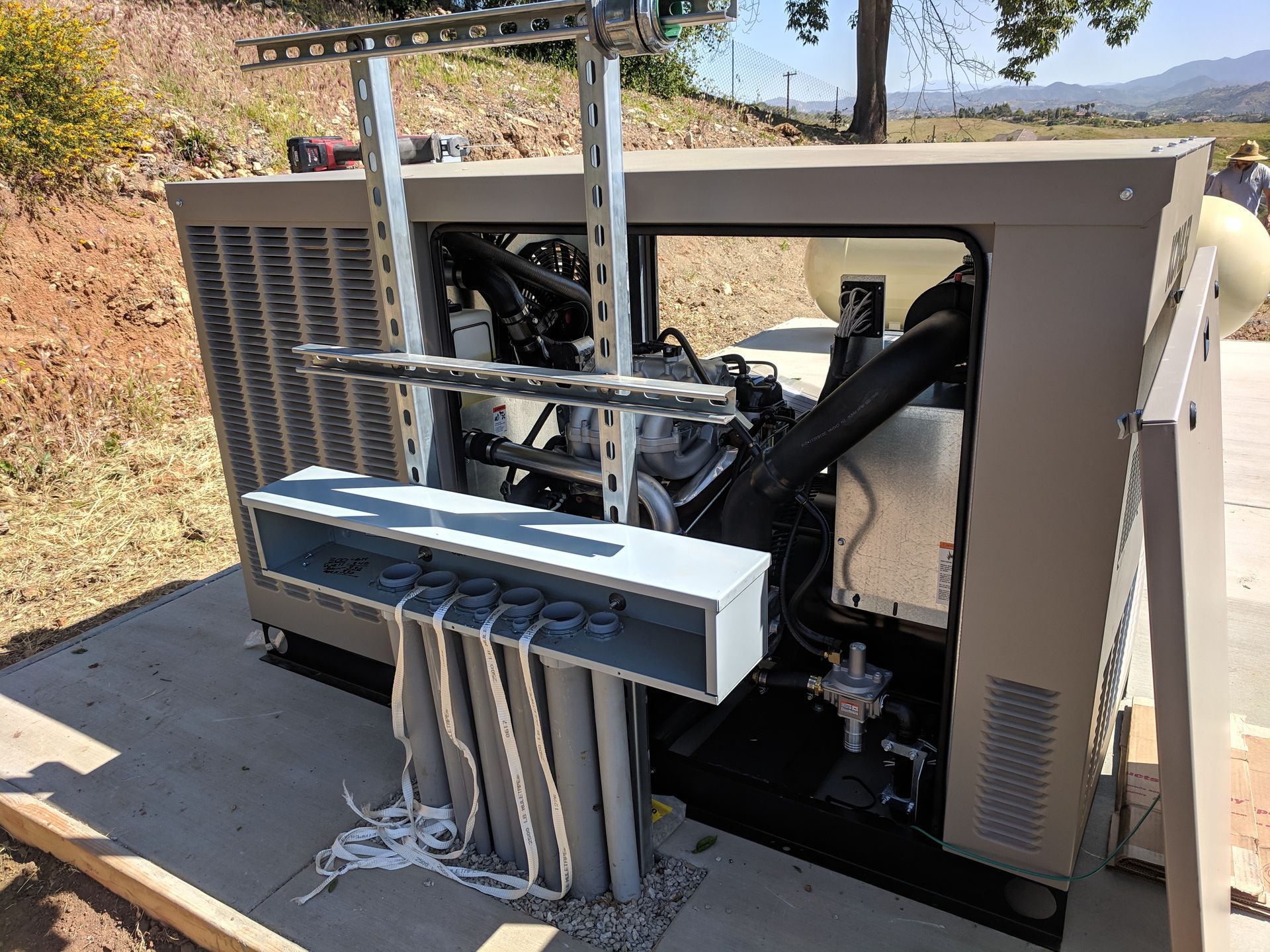 A generator is sitting on top of a concrete platform.