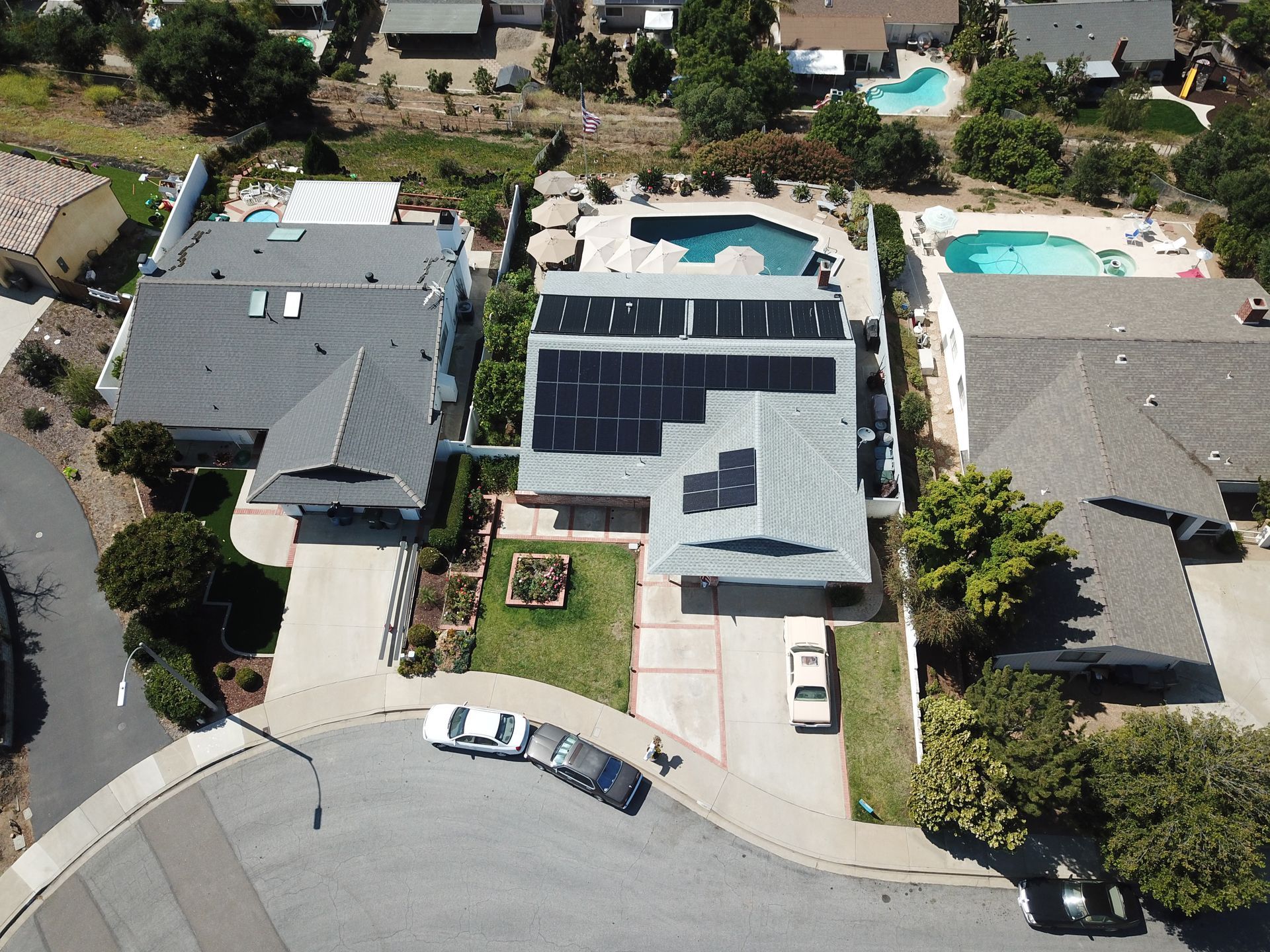 An aerial view of a house with solar panels on the roof