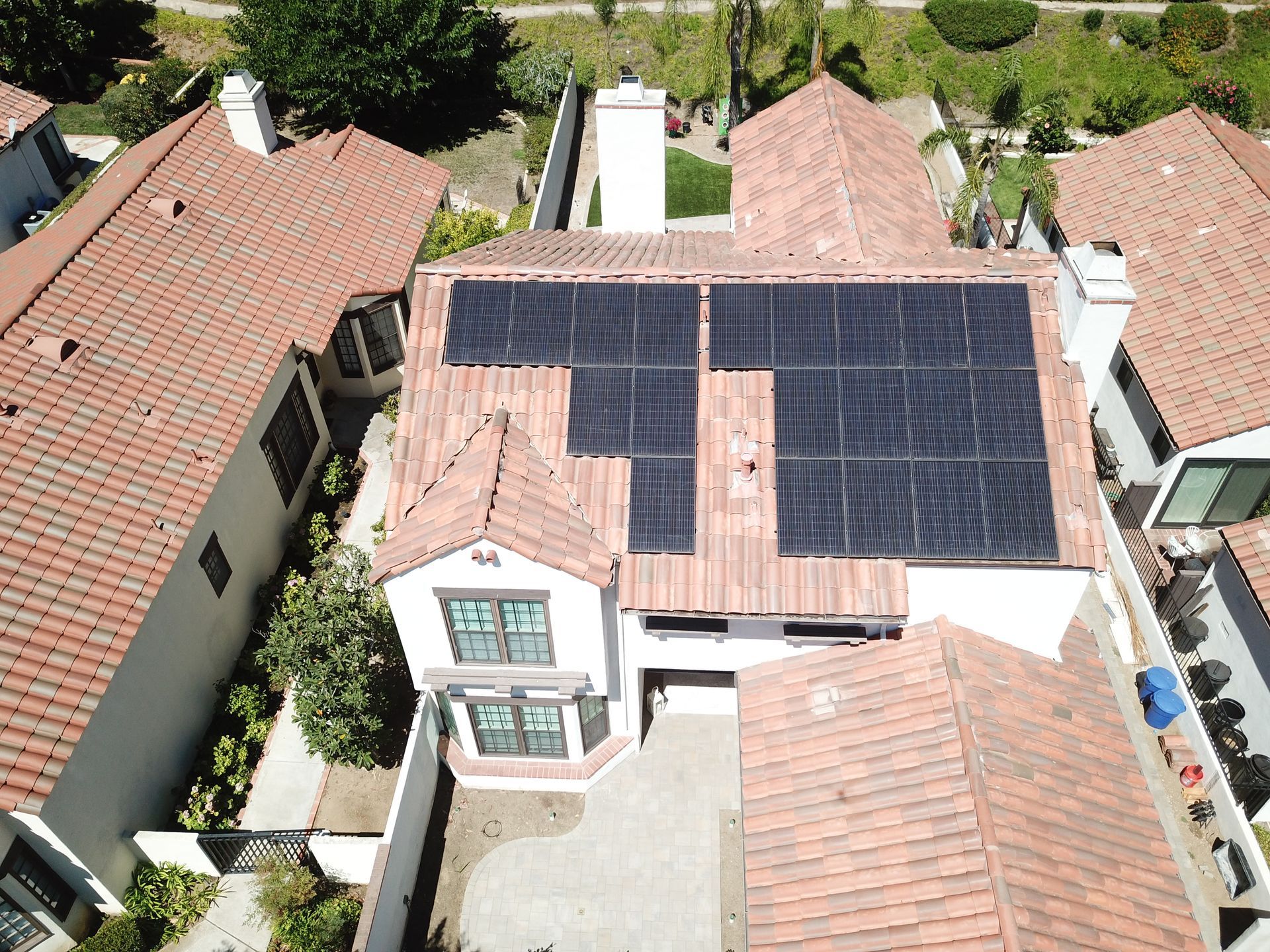 An aerial view of a house with solar panels on the roof.
