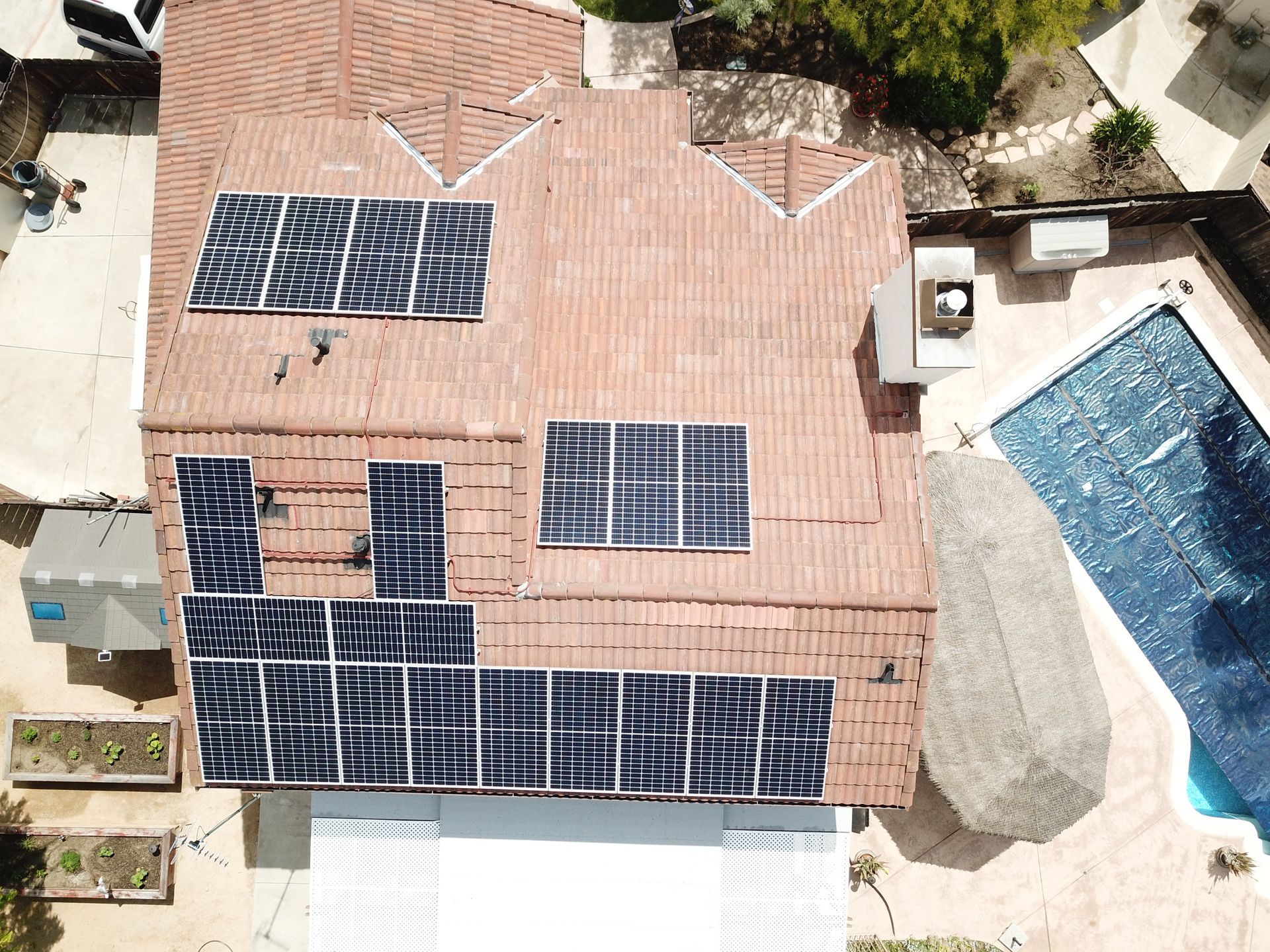 An aerial view of a house with solar panels on the roof