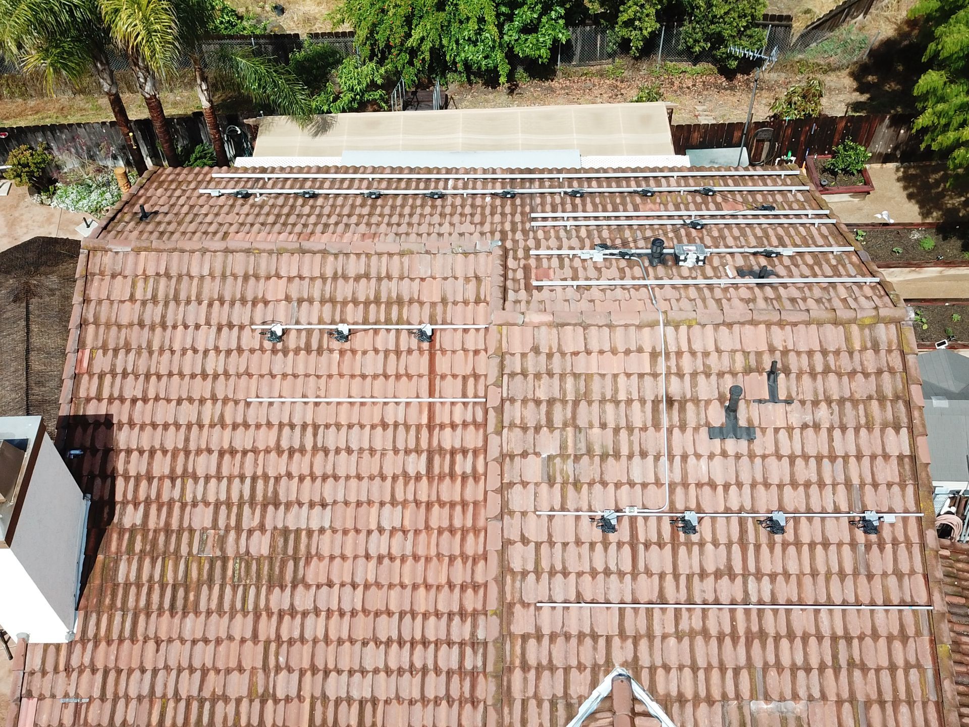 An aerial view of a roof with solar panels on it.