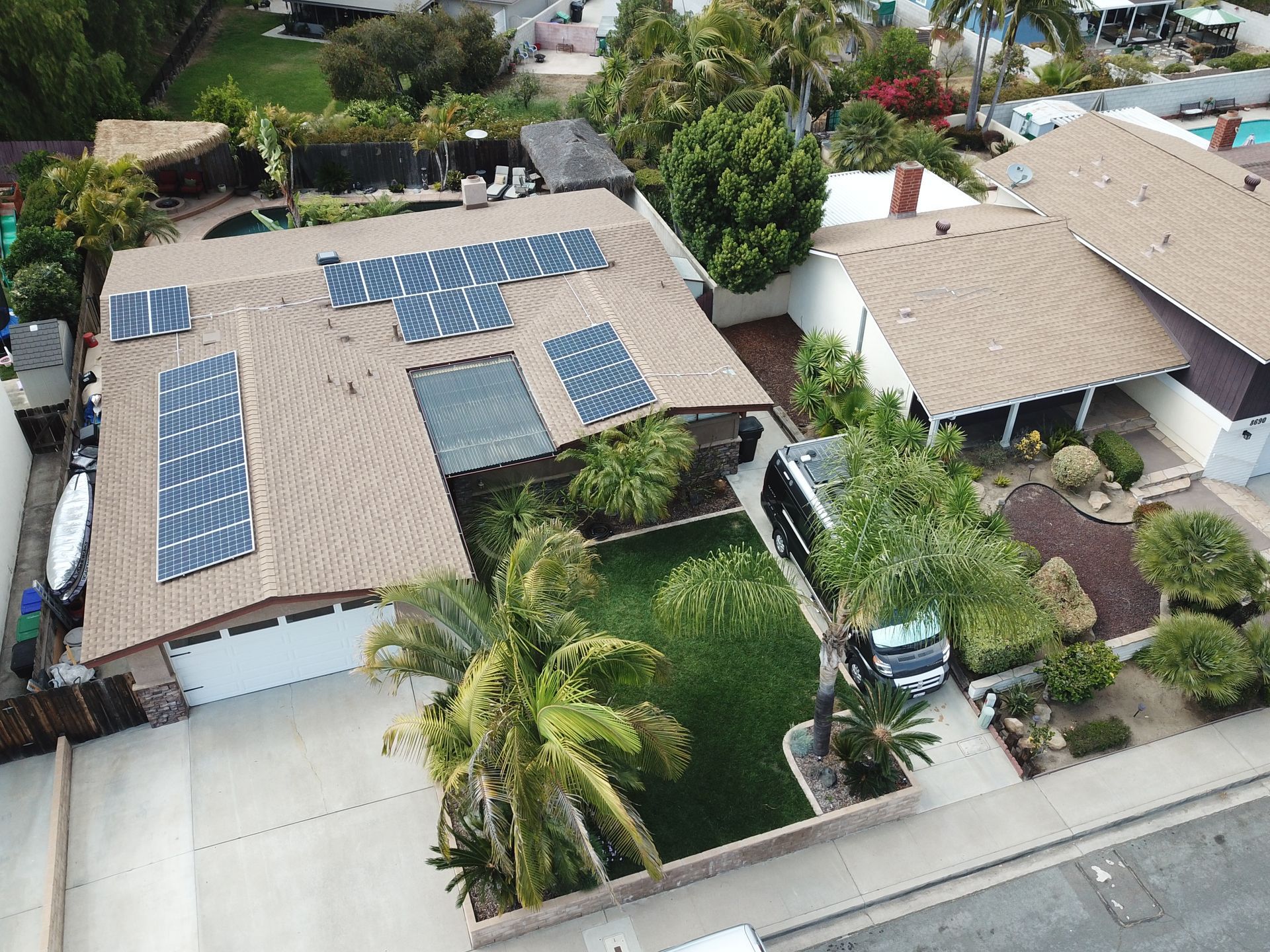 An aerial view of a house with solar panels on the roof