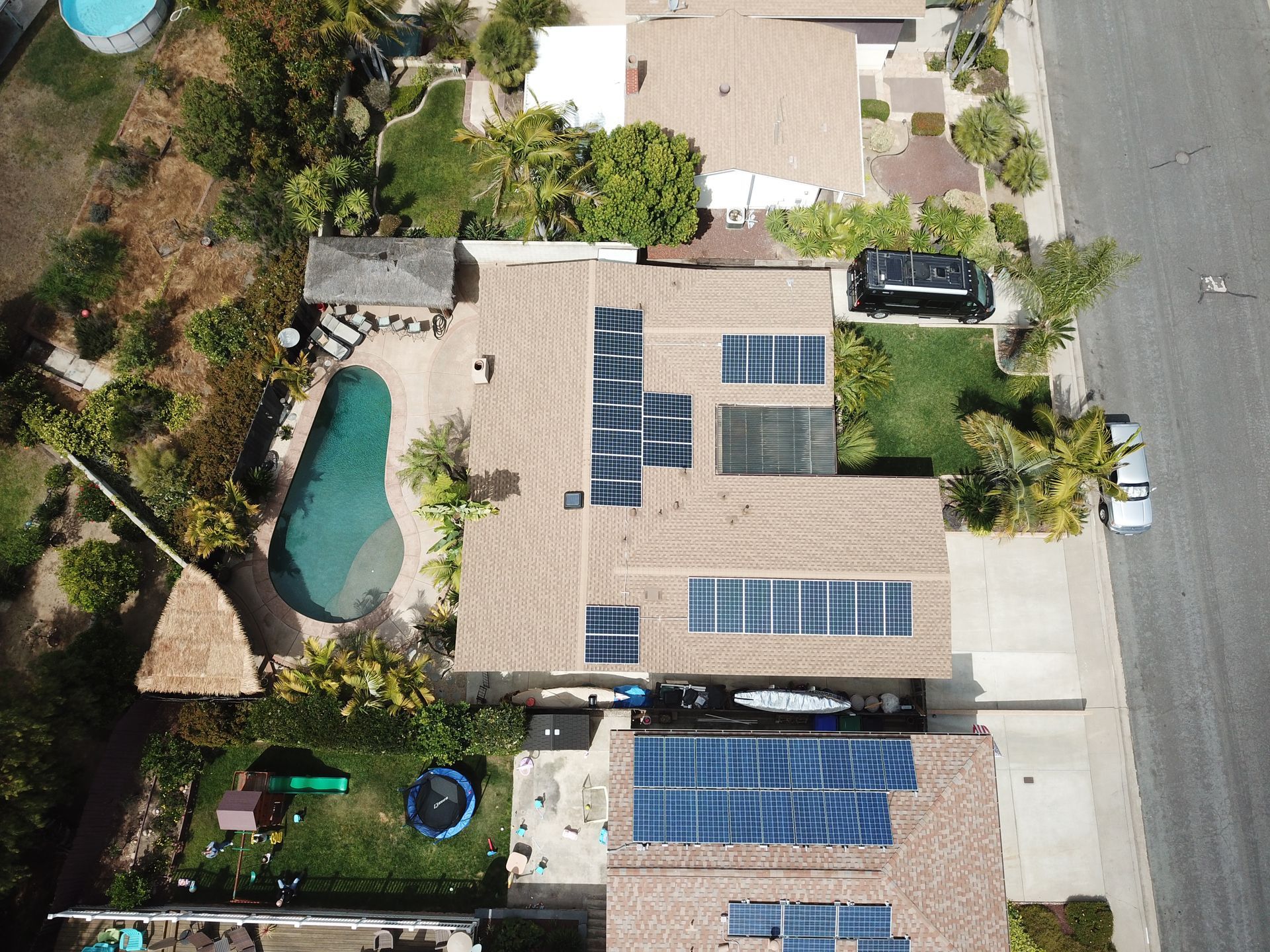 An aerial view of a house with solar panels on the roof