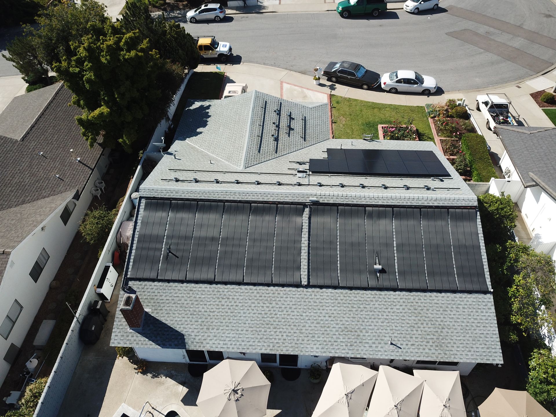 An aerial view of a house with solar panels on the roof
