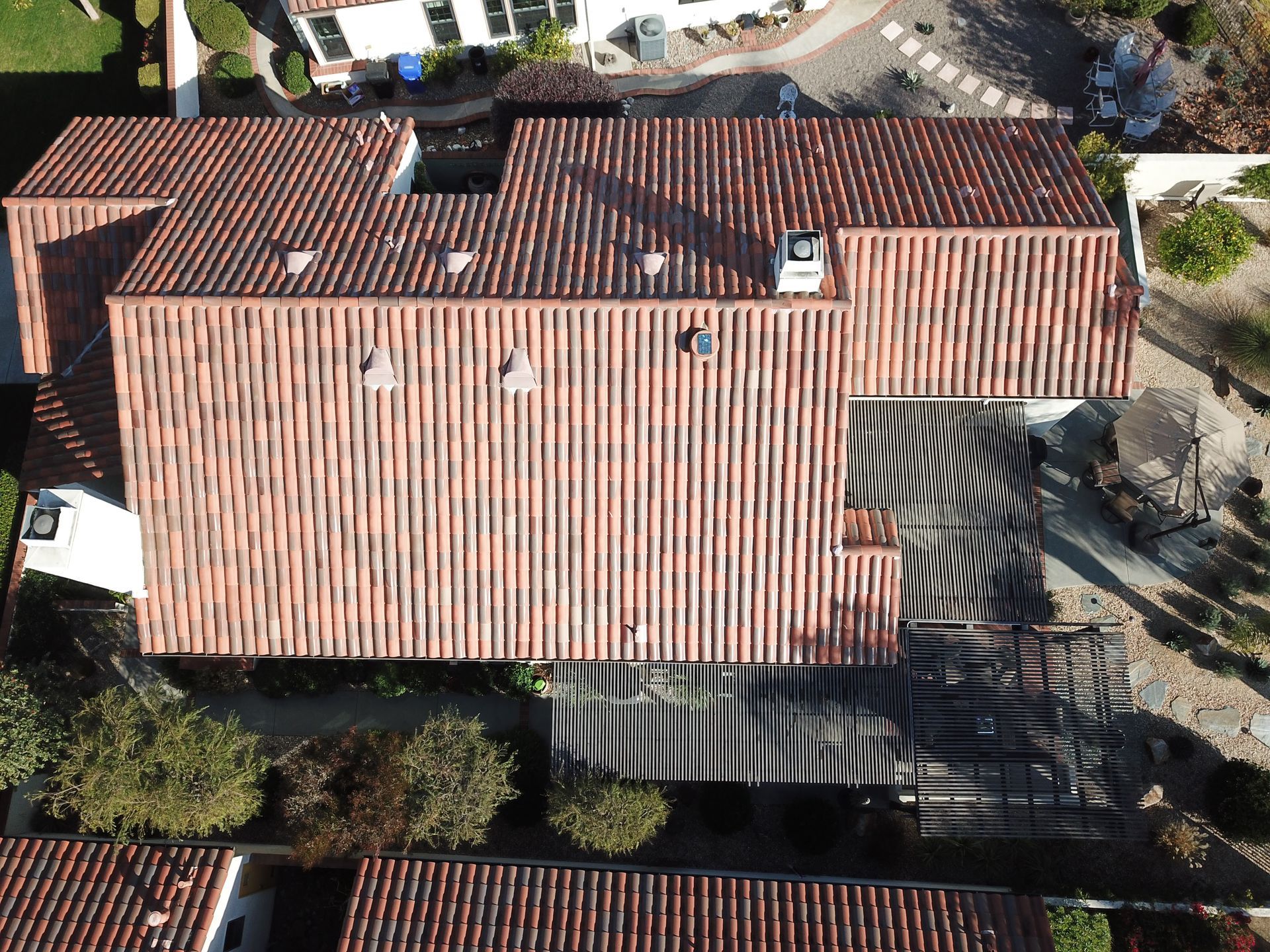 An aerial view of a house with a red tile roof