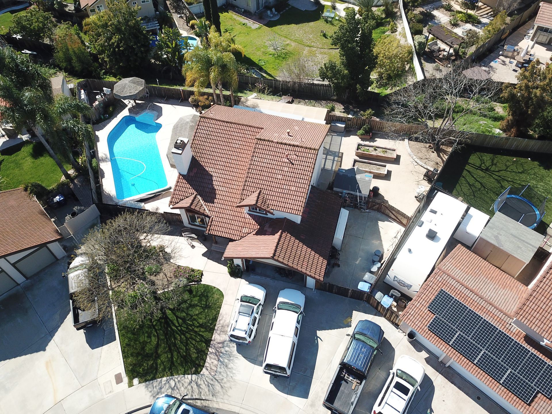 An aerial view of a house with a pool and solar panels