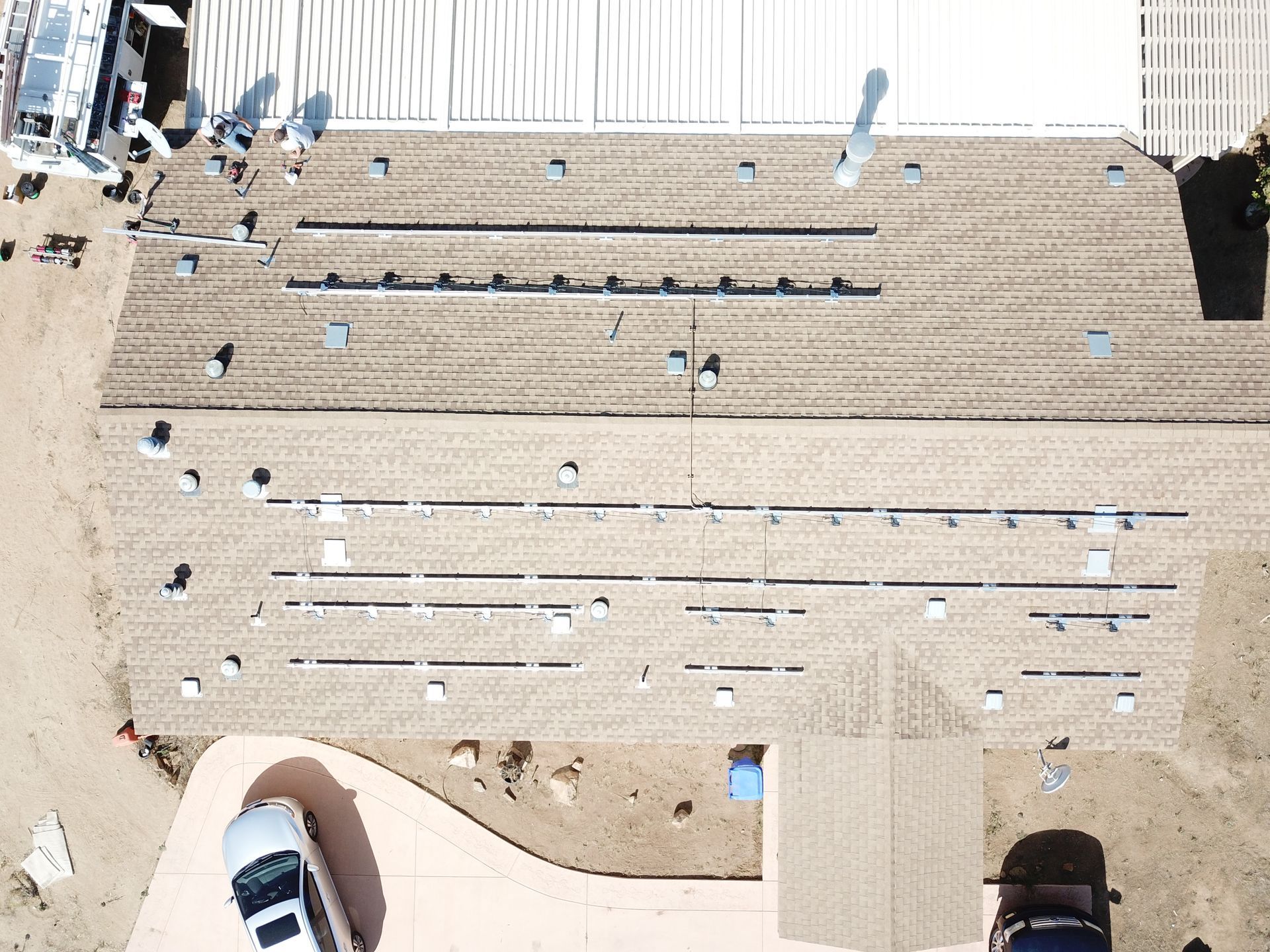 An aerial view of a building with a car parked in front of it