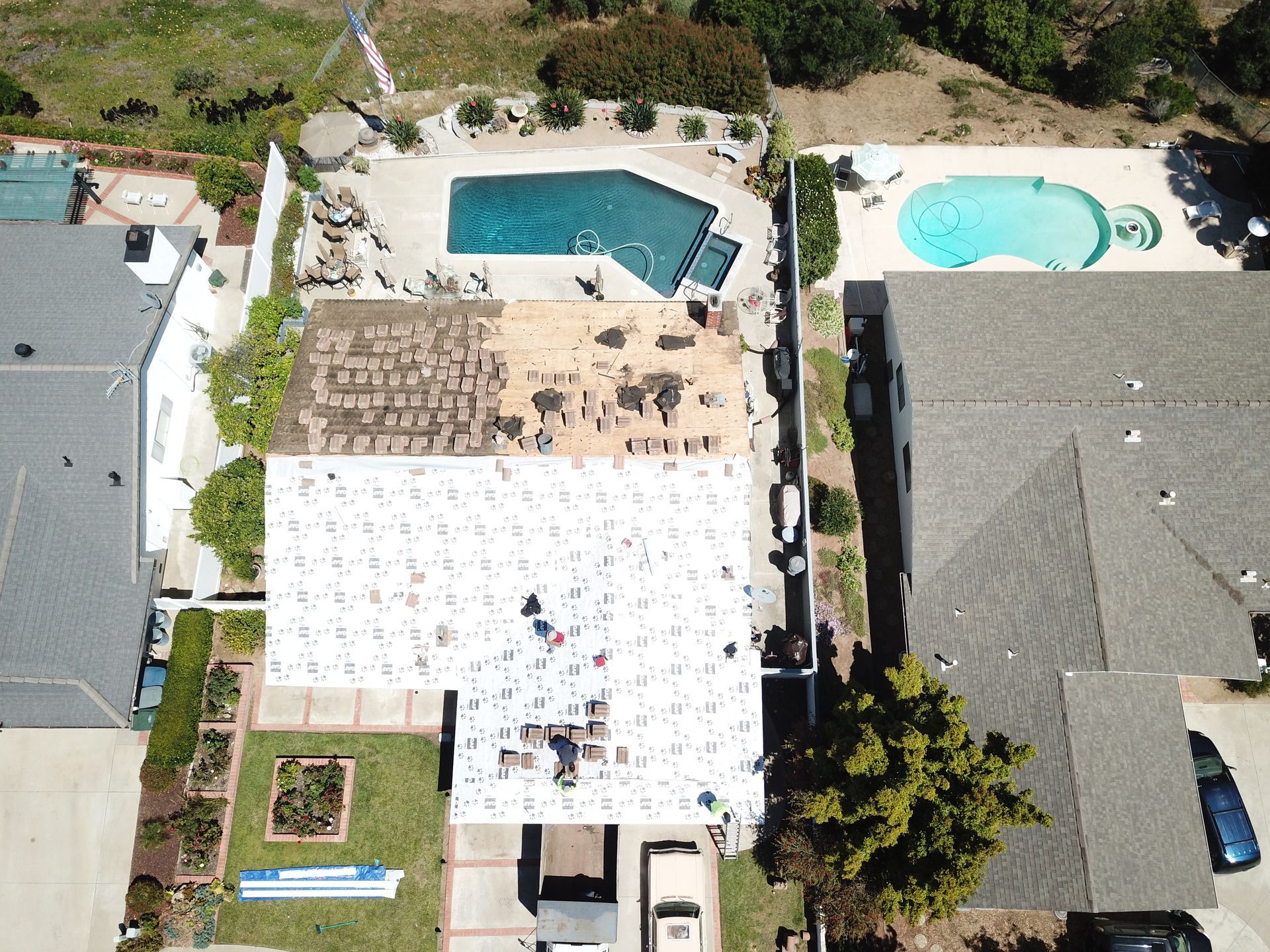 An aerial view of a house with a pool in the backyard