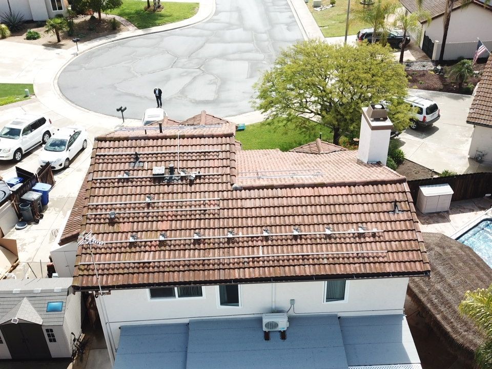 An aerial view of a house with solar panels on the roof.