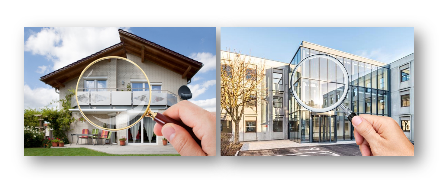 A person is holding a magnifying glass in front of a house.
