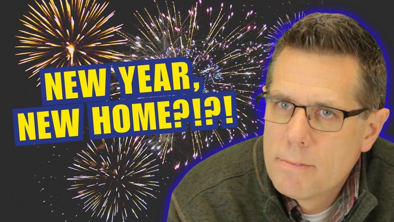 a man with glasses is standing in front of fireworks and says new year new home Wisconsin realtor