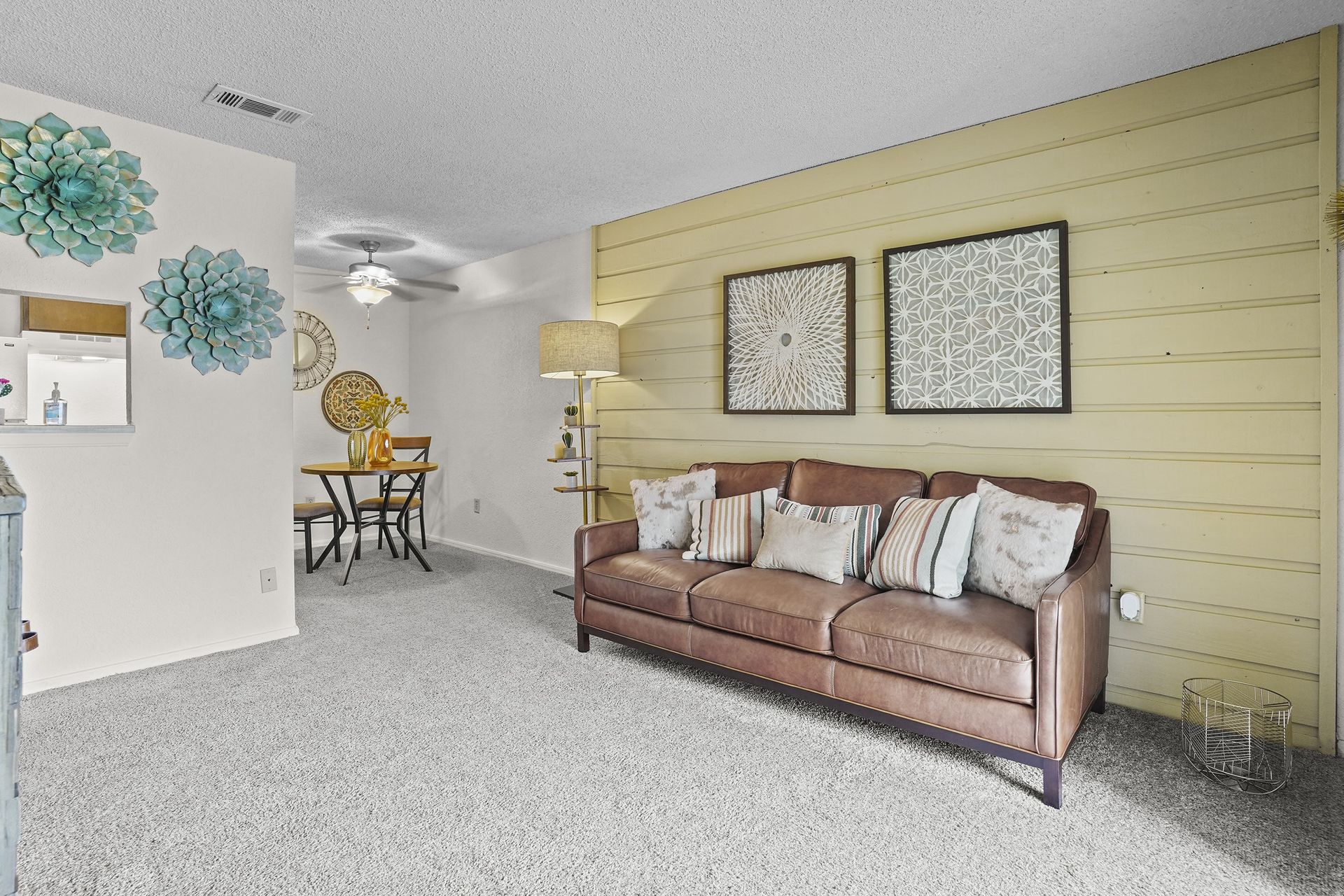 Cozy living room with a brown leather sofa and decorative wall art