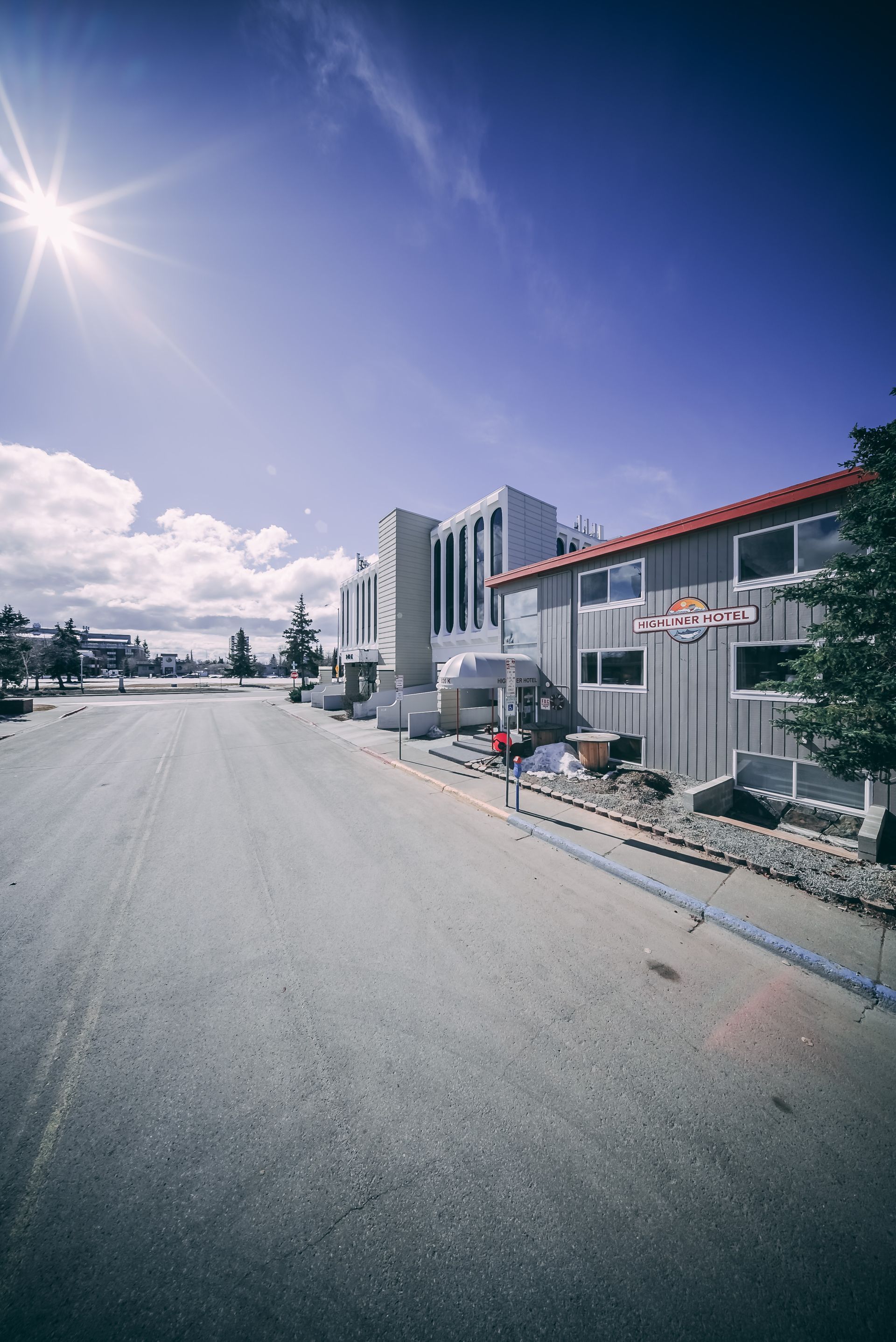 A row of buildings are lined up on the side of a road.