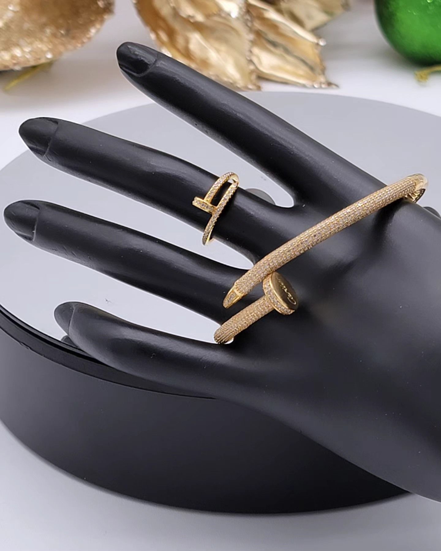 A black hand with a ring and bracelet on it