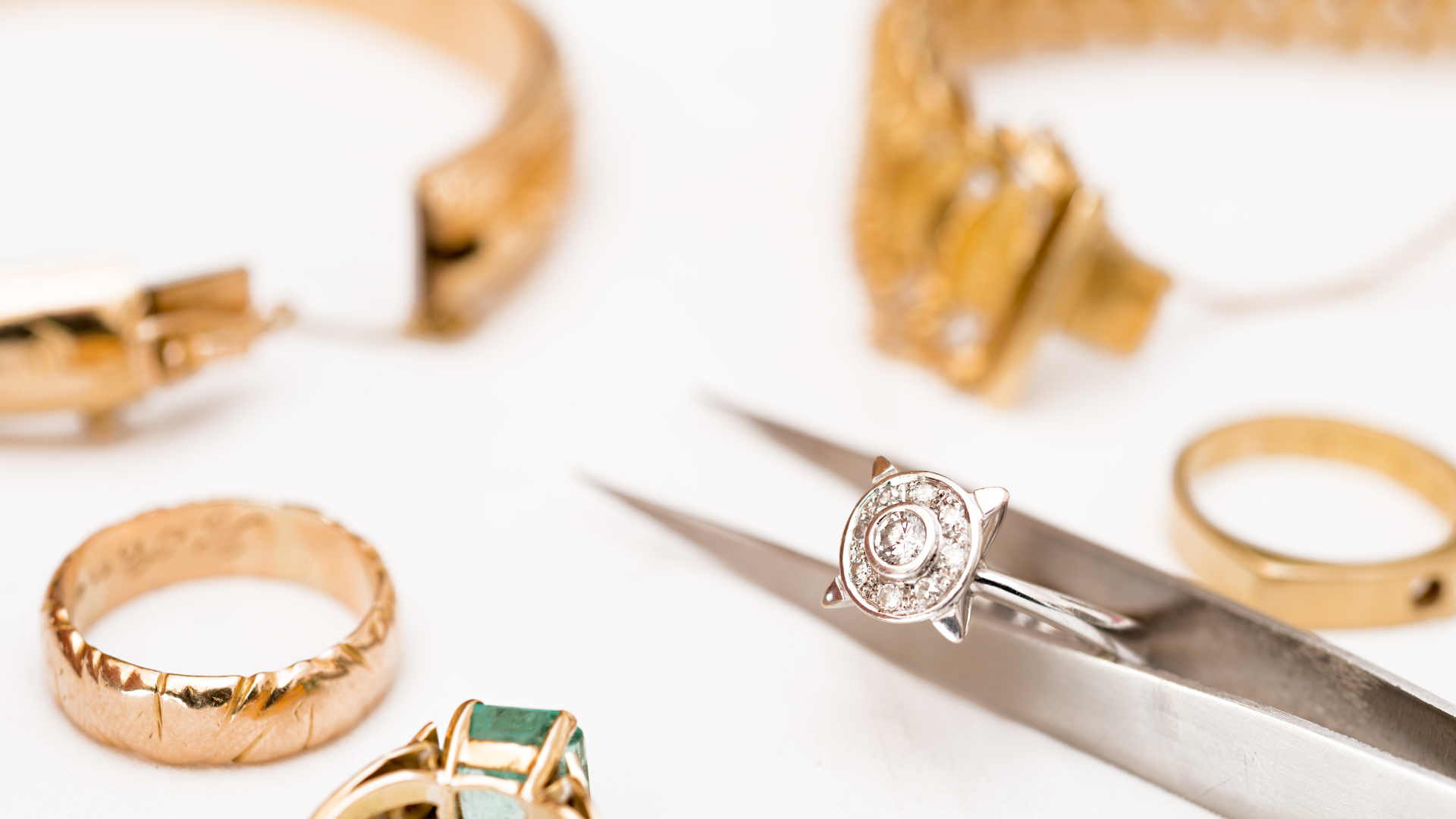 A diamond ring is being repaired by a pair of scissors.