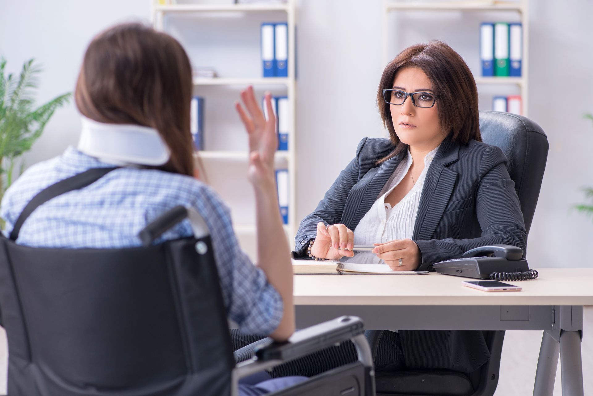 Injured employee visiting lawyer for advice on insurance.