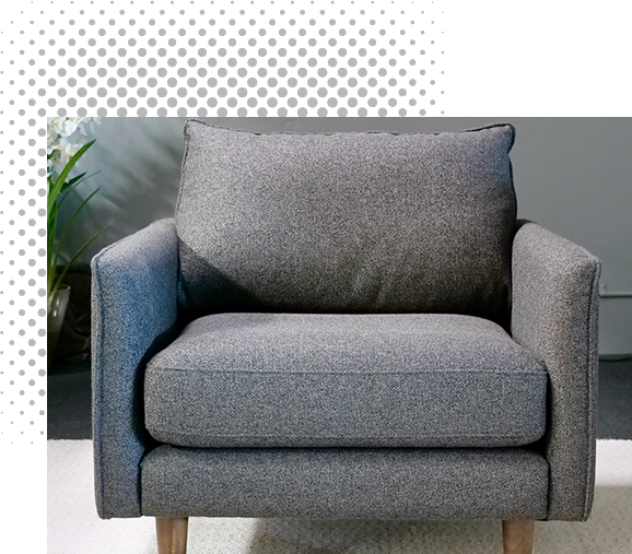 Gray upholstered armchair with wooden legs.