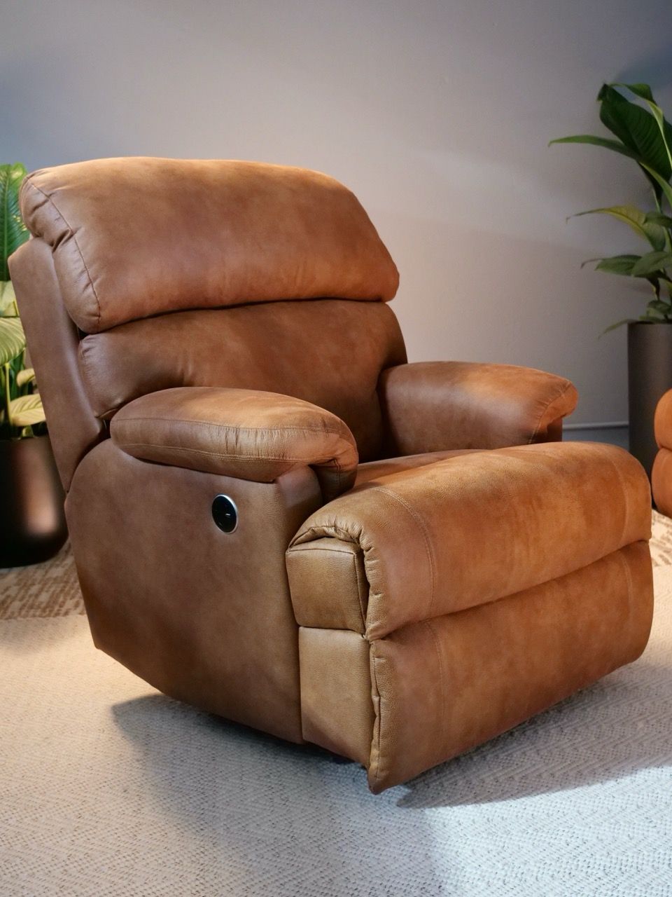 Brown leather recliner chair in a living room setting.