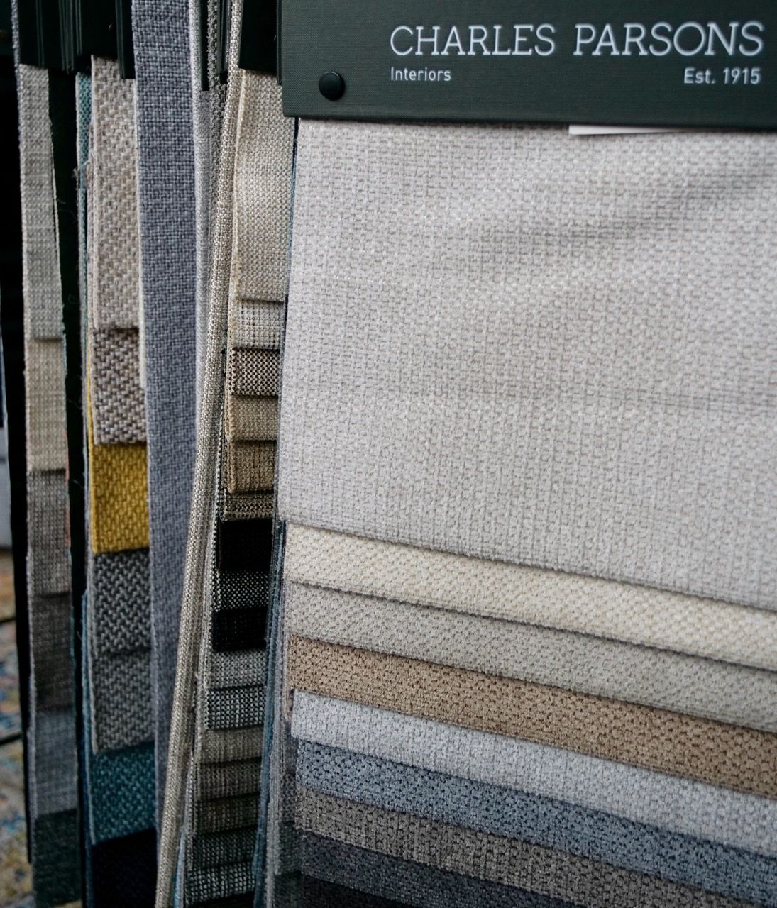 Fabric swatches in various neutral colors, Charles Parsons Interiors.