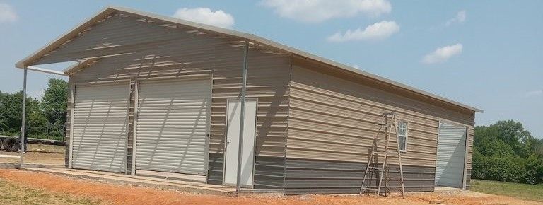 Metal building beside ladder - Asheboro, NC | Ciro's Carports & More LLC