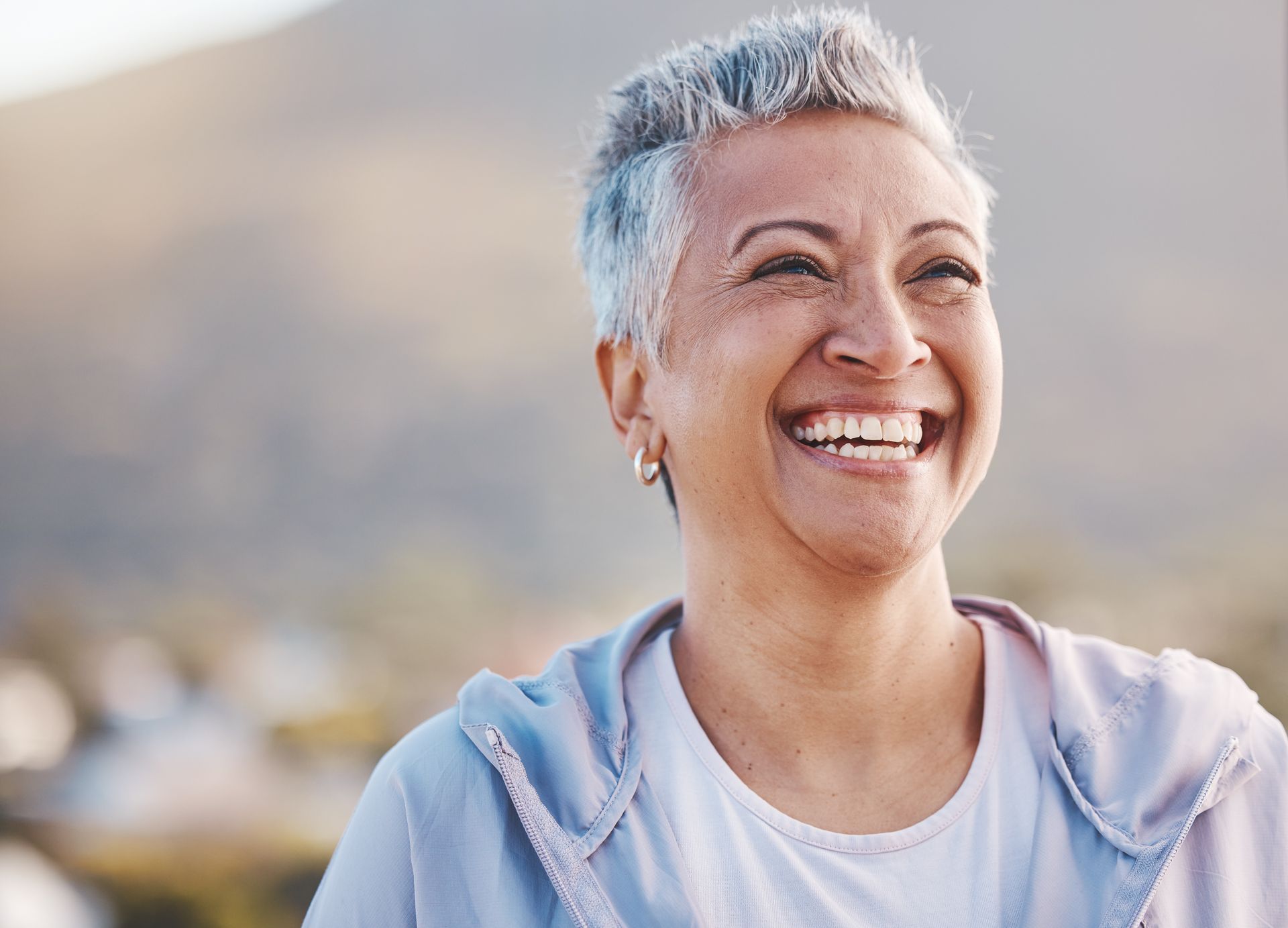 Photo of a smiling older woman with healthy teeth.