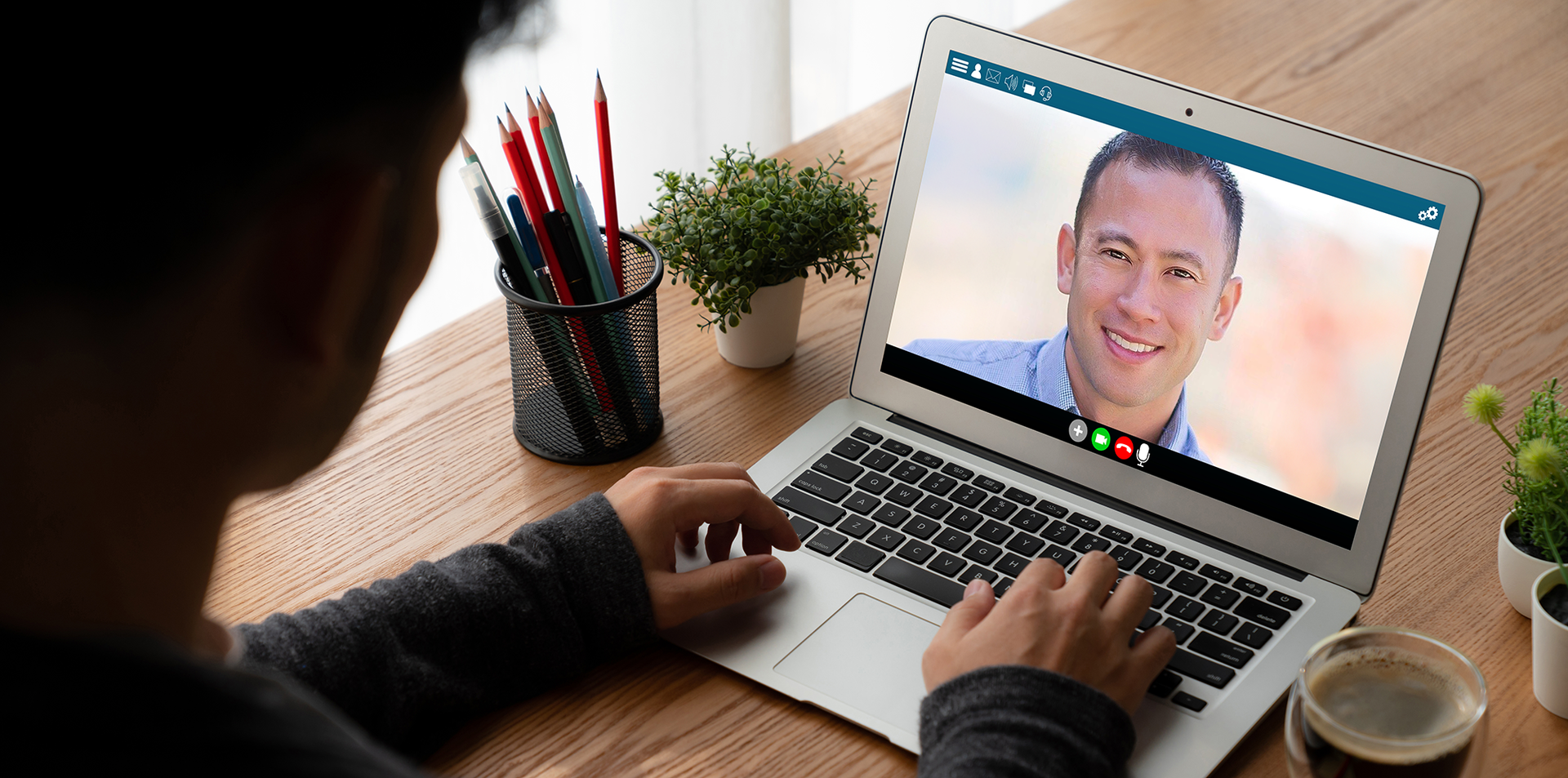 Photo of a man with a laptop computer during a virtual consultation. 