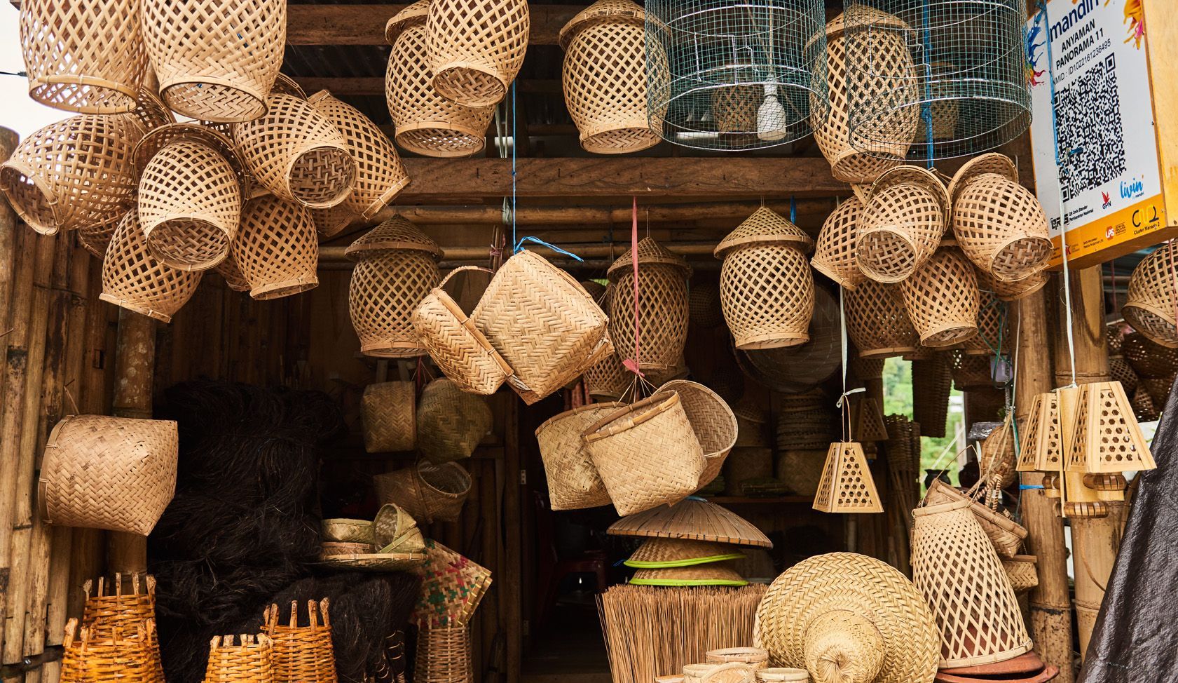 A store filled with lots of baskets hanging from the ceiling.