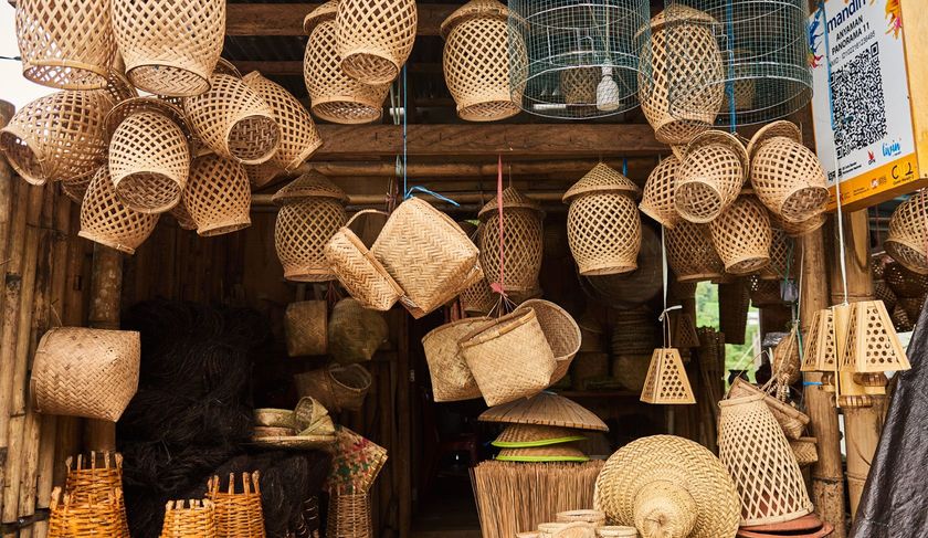 A store filled with lots of baskets hanging from the ceiling.