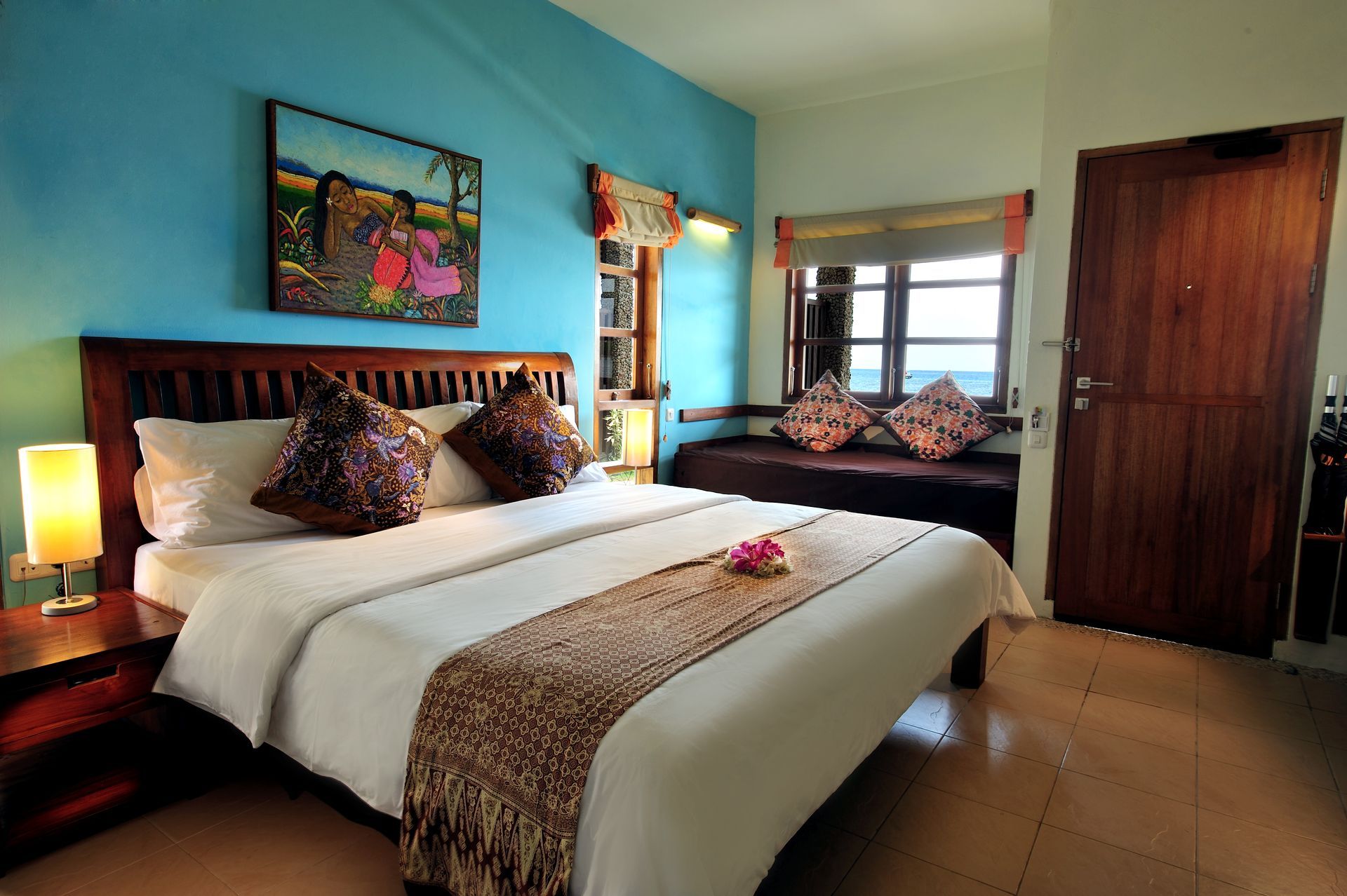 A hotel room with a bed and a window