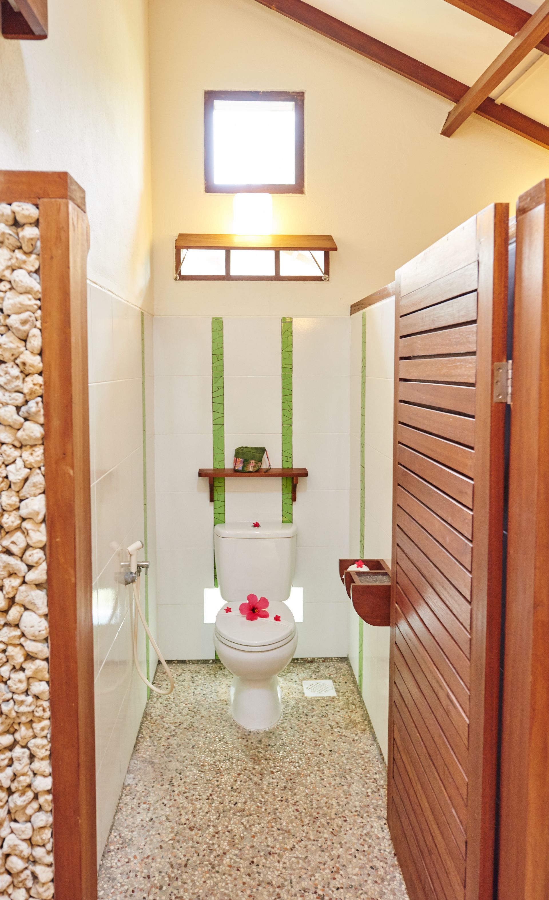A bathroom with a toilet and a wooden door